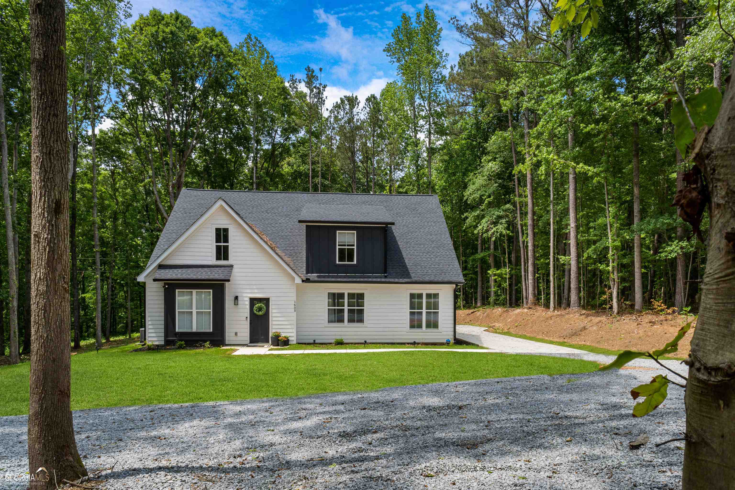 Beautiful 2022 Custom-Built home on 3.15 acres! Enjoy the quiet and natural beauty of the wooded landscape where you'll often see deer and turkey roaming. This spacious home boasts an open concept living space! Owner's Suite on the main floor with large walk-in closet, a luxurious on-suite bathroom featuring a large tiled shower and double vanity, an additional space that can be used as an office or an additional walk-in closet. A large open area upstairs before you enter two additional oversize bedrooms and one full bath. Gourmet kitchen with large kitchen island, granite counter tops, ample counter space and storage options, all stainless steel appliances, large pantry, mud room, separate laundry and a half bath on the main floor! Beautiful LVP flooring and tile throughout the entire home, large covered back patio that's great for entertaining and plenty of yard for gardening and just waiting for your new pool. This one has it all! Schedule your showing today and see all that this home has to offer!!