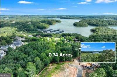 We are proud to announce we are nearing the completion of Marina Bay and the development of its last remaining lots. This lot, located on The Ridge, is a fully developed .74 acres lot with one Marina Bay Boat Slip License included in the price. This fantastic Lot not only has soft topography making it easy to build on but long range uninterrupted panoramic views of Lake Lanier all the way to Harbour Point. The lot's rare location also has mountain views and sits at the end of Marina Ridge Road which has the largest size Estate lots in Marina Bay! Not having corps property on the lot, it can be groomed to maximize the views in a 180-degree range. Its magnificence is more than matched with the natural beauty of Marina Bay's tree-lined streets, lush amenities and gated elegance for only 251 families. HOA Fee is $3,000 per year and Marina boat slip fee is $500 per year. The best of all worlds with year-round activity for all members of the family or the serene quiet of the northern lake and Marina Bay's deep tucked away cove setting. Plus, the warm welcoming of lake life forever friends in Marina Bay. Outdoor living every day is our life here in Marina Bay. My family loves it and we have had more lake time than we ever imagined. Plus living on the North Shore of Lake Lanier also gives you access to the fun North Georgia Mountains lifestyle. Come be a part of the wonderful loving community of Marina Bay. There is something for every member of the family and a professionally managed HOA team that helps us maintain an active year round calendar of fun activities. Grab your golf cart and be on the lake 5 minutes later. Better yet in the resort style salt water pool with waterfall, beach entry, stone cabana with outdoor grill kitchen and fireplace or get in a good workout in our full fitness gym. Enjoy evening walks on the tree lined streets and chatting with the friendly families who love their lake lifestyles here in Marina Bay.