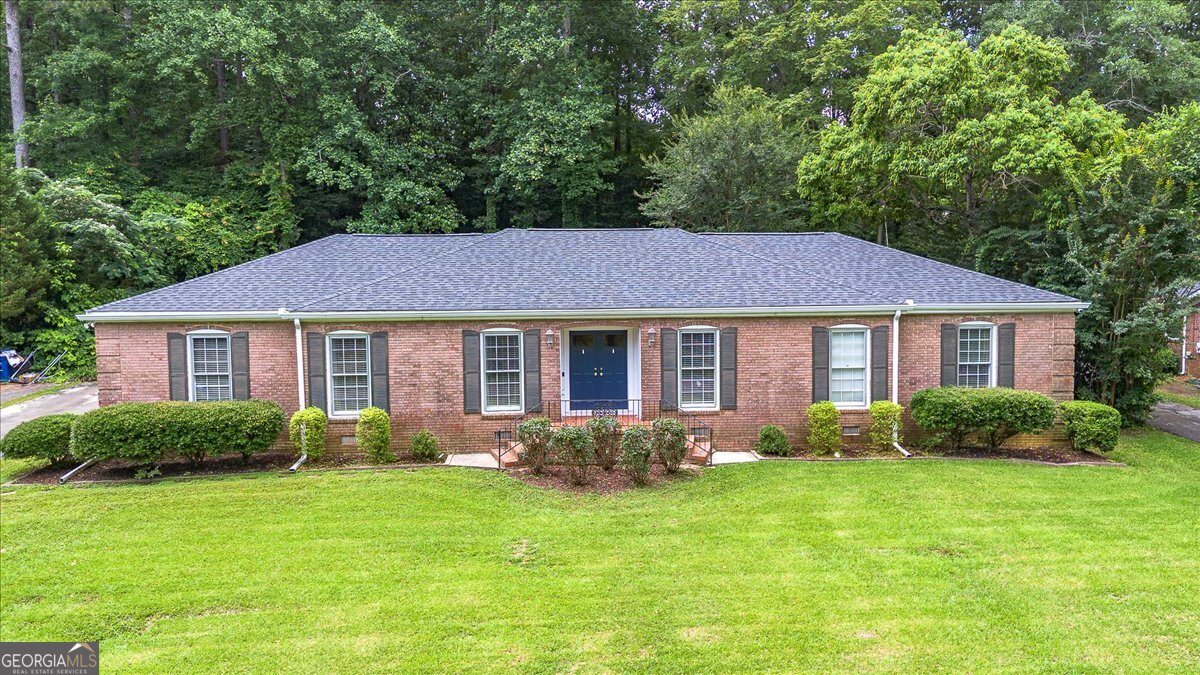 Spacious All-Brick Ranch in Prime Macon Location Welcome to this well-maintained 4-bedroom, 2.5-bath all-brick ranch-style home, offering nearly 3,000 sq ft of comfortable living space in the heart of Macon. This home blends timeless charm with practical living, perfect for families or those who love to entertain. Inside, you'll find a spacious family room, a formal living room, a welcoming foyer, and a dedicated dining room-ideal for gatherings both casual and formal. Real hardwood floors add warmth and character to the bedrooms and hallway, while the heated and cooled sunroom provides a versatile space for year-round enjoyment. Outdoors, enjoy a fully fenced backyard featuring a custom-built swing set and a large front yard with a beautifully kept lawn. A large workshop off the car carport offers extra space for hobbies, tools, or storage. Recent updates include a new HVAC system (2023) and a roof replacement (2021), providing modern comfort and peace of mind. With a central location just minutes from shopping, dining, and everyday conveniences, this property truly has it all. Don't miss this opportunity to own a spacious, move-in ready home in one of Macon's most accessible areas!
