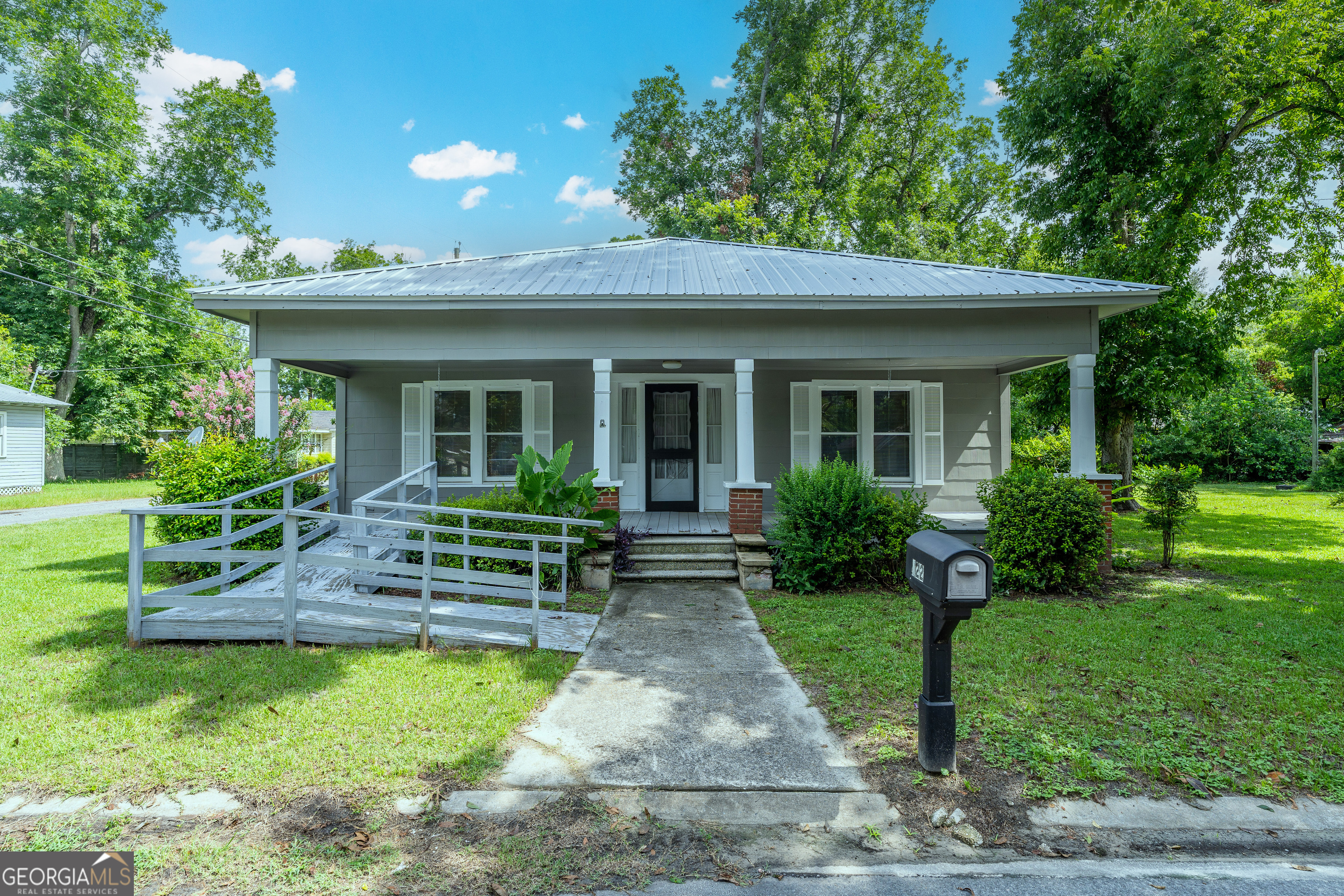 Charming Cottage in Ware County - Full of Character! This adorable 3-bedroom, 1-bath cottage is brimming with charm and ready for your personal touch. Located in Ware County just minutes from town, it features a spacious dining room, original fireplace mantels that highlight the home's historic design, and inviting front and back porches perfect for relaxing. Set on a beautiful lot with mature pecan and fig trees, this property combines comfort and charm. Major updates include a new roof, new HVAC, and fresh exterior paint-the big stuff is done, now it's ready for your finishing touches! Don't miss this one-of-a-kind home in a peaceful setting close to it all.