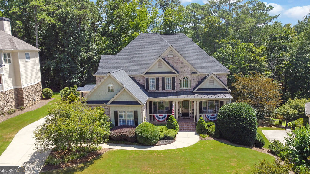 Welcome to 3215 Waterhouse Street! A meticulously maintained gem nestled in one of Kennesaw's most desirable neighborhoods! This lovely, cared-for home offers thoughtful updates and elegant finishes throughout, including a newer 30-year architectural roof (2021) and hardwood floors across both the main and upper levels. Upon entering, you're greeted by your very own private library! A rare find, complete with custom-built-in bookshelves and designer lighting. Just across the foyer, a separate formal dining room awaits, perfect for hosting gatherings or spending quality family time. Chef's kitchen, boasting a double oven, gas cooktop, and an abundance of cabinet space, which includes under-cabinet lighting. Two spacious living areas provide flexibility and comfort, whether you're entertaining guests or enjoying a cozy night in. The oversized garage is equally impressive, featuring epoxy floors, wainscoting, and insulated garage doors. The converted mudroom adds extra convenience and houses the laundry area with smart design in mind. Upstairs, you'll find four well-appointed bedrooms, including an expansive primary suite with tray ceilings, a private sitting area, and a luxurious en-suite bath. The walk-in master closet is thoughtfully designed with an ample amount of space and a wall-mounted ironing board for added functionality. The finished basement is an entertainer's dream-complete with a large open living space, kitchenette, full bedroom, full bath, plus a dedicated workshop and additional storage area! Step outside and enjoy your private outdoor oasis! Relax on the low-maintenance TREX deck, gather around the stone fire pit, or admire the professionally landscaped backyard with stone retaining walls, steps, and accent lighting-a perfect retreat after a long day. Do not miss this rare opportunity to own a truly special home in Kennesaw, GA! Schedule your private showing today!