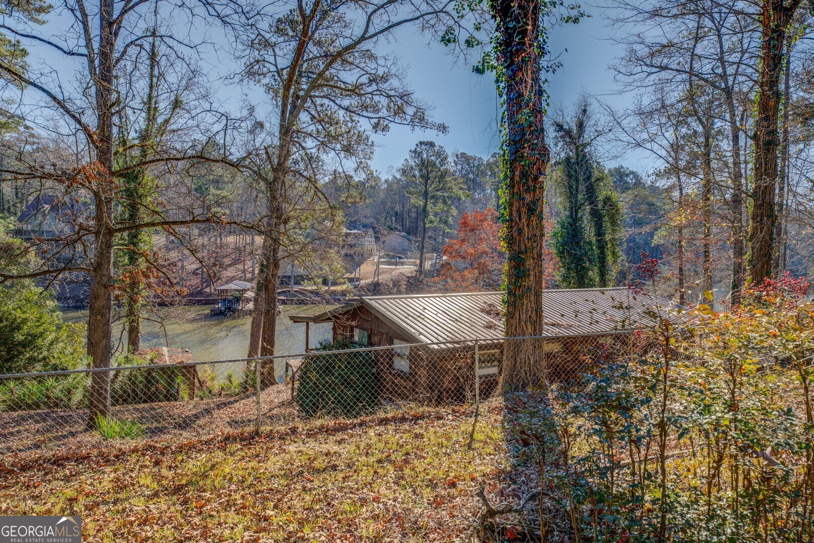 Family has lived in this cottage since the 70's just as is. Nestled in a quiet cove on the Tussahaw in Butts county on almost 3 acres and 400 feet of shoreline. Can be used as a cottage as is.... or use as an amazing property to build your dream lake home in one of the best locations on the entire lake. Priced to sell as is.
