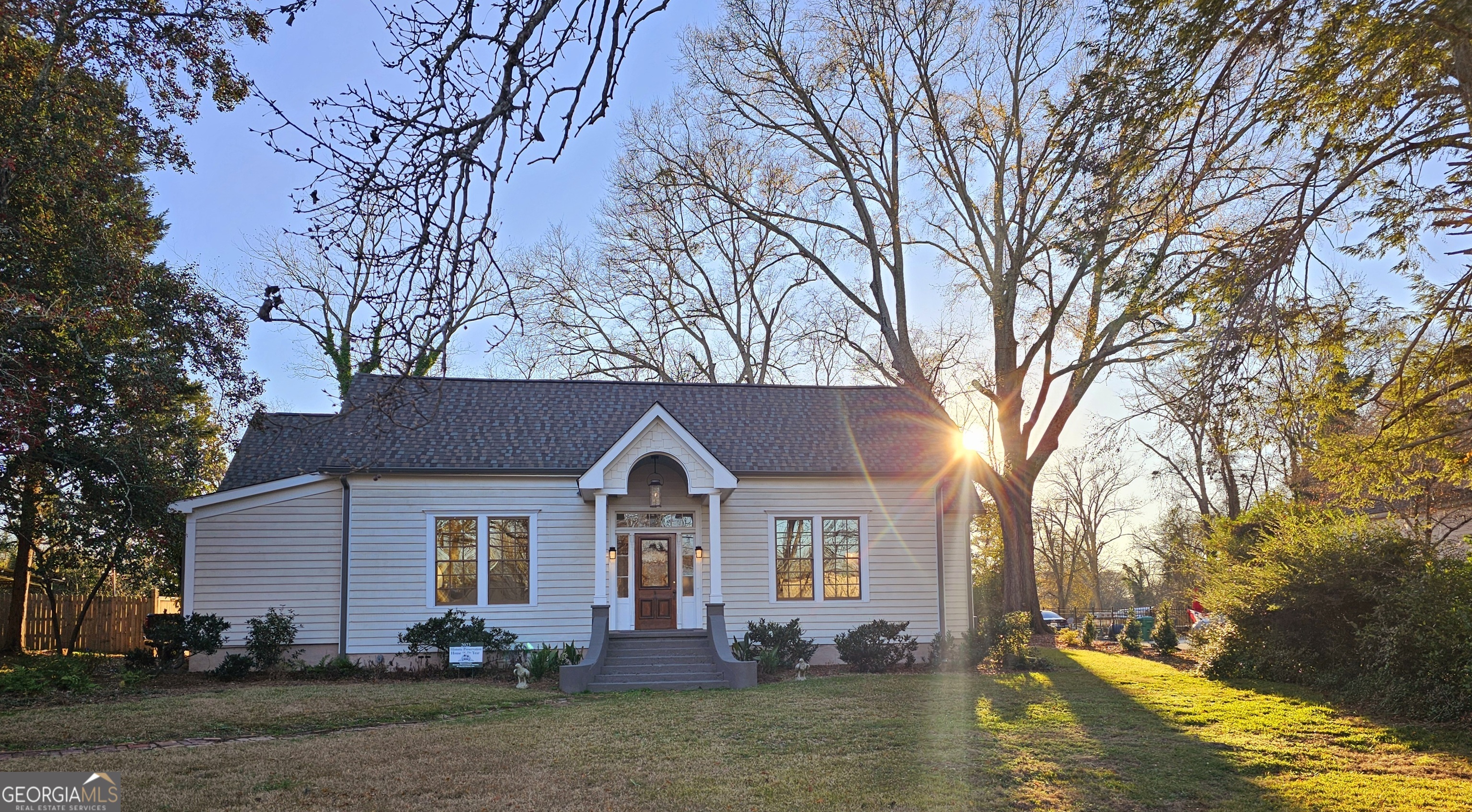 Priced below Appraisal to Sell. Historic District-walking distance to city schools, churches, library, post office, parks, professional services, & downtown dining. A 2,800 SF, one of a kind complete reno & New Construction ('24& '25) of a circa 1860's home that includes 85%-90% NEW Construction bringing modern amenities into the character & beauty of a truly historic house. Featuring 10 foot ceilings on the main floor, custom wood baseboard & crown mouldings, architrave or lintel with plinth blocks surround 5-panel, custom wood doors. An upstairs room has a beautiful view of the huge backyard through a 60" x 48" custom Jeldwen casement window. The 3 full bathrooms feature custom & marble tile, tiled showers, a master shower with a walk through glass entry & marble bench, hand-selected granite countertops, custom vanities, Kohler, Signature, & Delta hardware Fixtures, separate water closets in the Master and guest bathrooms, TopKnob custom cabinet hardware in the master bath. The 1/2 bath includes an antique vanity with drop in hammered copper sink & lavatory. There are 2 original historic Quartersawn oak mantels, one attached to a masonry chimney in the living/dining area and the other in the guest bedroom. Original and reclaimed restored heart pine flooring throughout, & an open, lit staircase with solid red oak treads & banister with basket iron spindles leading from the kitchen & living area to the second story room above the kitchen. The upstairs and spare bedroom and walk in closets are newly carpeted. The exterior is 100% NEW wood siding. The attic and walls are fully insulated with closed cell air foam insulation and batten insulation. All energy-efficient new, Tucker wood windows were installed in compliance with the city's Historic Review Board's guidelines. The roof is new and all of the interior & exterior is freshly painted. ALL plumbing, wiring, HVAC system, & 2 tankless hot water heaters are NEW. All old plumbing and wiring were removed and is in compliance with current code. An outstanding feature of this home is the large, dine-in, Gourmet kitchen, which features: All new high end, stainless steel Thor Appliances & Multifunction Vent Hood; separate pantry; new custom wall cabinetry with beautiful granite counter tops; a huge bow-shaped, custom island that includes a double sink, custom, solid slab, granite top and extensive island cabinet storage space with dishwasher; custom hardware. Custom built wall cabinets and countertop include a separate prep sink; below countertop microwave; & an in-counter freestanding ice maker. A 20.9 Cu.Ft. Thor refrigerator is at counter depth with French doors & automatic ice maker. For those who love to cook, there is 48" Pro Style Dual Fuel Thor Range with convection oven fan, double ovens, cast iron cooking grates, 7 burners, & an infrared griddle with a pot filler above the range. A separate enclosed laundry room with a marble floor covering & a deep laundry sink with cabinet are reached through a short hall from the kitchen. Underneath the stairwell & open to the kitchen is a small desk & nook with shelving that includes a cozy getaway for your pet. There are wafer and custom lighting with dimmers throughout the house. The Master BR is on the main floor, all 4 bedrooms have closets, 3 are large walk-in closets and all 3 downstairs BR's all have ceiling fans. Outside, original laurel shrubbery was saved, new landscaping was added and the private backyard is open, level, & sodded with Bimini Bermuda grass & shaded by mature trees. The level, open lawn is surrounded by a wood privacy fence on 3 sides, a brick sidewalk from the drive leads to a private brick patio. The front arched & covered entry showcases a custom-made pendant gas lantern made by Flambeaux Lighting in New Orleans. Refer to the included documents for an expanded description. A letter of credit or certification of funds will be respectfully requested prior to scheduling a showing