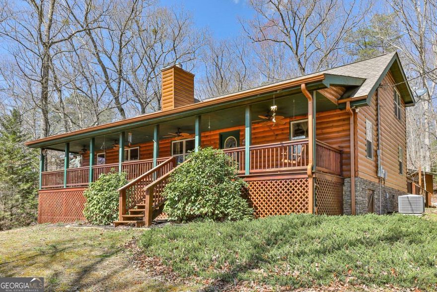 Welcome to your peaceful escape in the heart of the N GA mountains-where comfort meets charm in the sought-after Magnum's Pride community. Tucked away on a gentle, useable lot, this inviting cabin offers the perfect blend of privacy, functionality & mountain magic. Start your day with a cup of coffee on the spacious front porch, where rocking chairs & fresh mountain air set the tone for pure relaxation. Out back, a huge rear deck & custom stone fire pit create the ultimate space for outdoor entertaining-whether you're roasting marshmallows under the stars or hosting a cozy gathering with friends & family. Step inside to discover a bright & expansive great room featuring a stunning two-sided gas fireplace that adds warmth & ambiance to both the living & dining areas. With the addition of 600 sqft of open living space, there's plenty of room to stretch out & relax after a day of exploring. The kitchen is thoughtfully designed with bar seating, perfect for casual meals & it flows seamlessly into the main living space, making entertaining effortless. On the main level, you'll find 2 spacious bedrooms & full bath, while upstairs offers a private bedroom retreat complete with its own en-suite bath-ideal for guests or a luxurious owner's suite. Outside, the storage shed with extended roof provides plenty of space to stash your kayaks, fishing gear, or mountain bikes, keeping your gear organized & ready for the next adventure. And with the mostly level yard, there's plenty of room for pets, yard games, or enjoying the great outdoors. Located just minutes from the best of the area-hiking trails, fishing spots & all the shopping & dining in Downtown Blue Ridge-this home offers the convenience of easy access without sacrificing the serenity of mountain living. Whether you're looking for a full-time residence, vacation getaway, or income-producing rental, this warm & welcoming cabin checks all the boxes. Come experience the perfect mix of rustic charm & modern comfort.