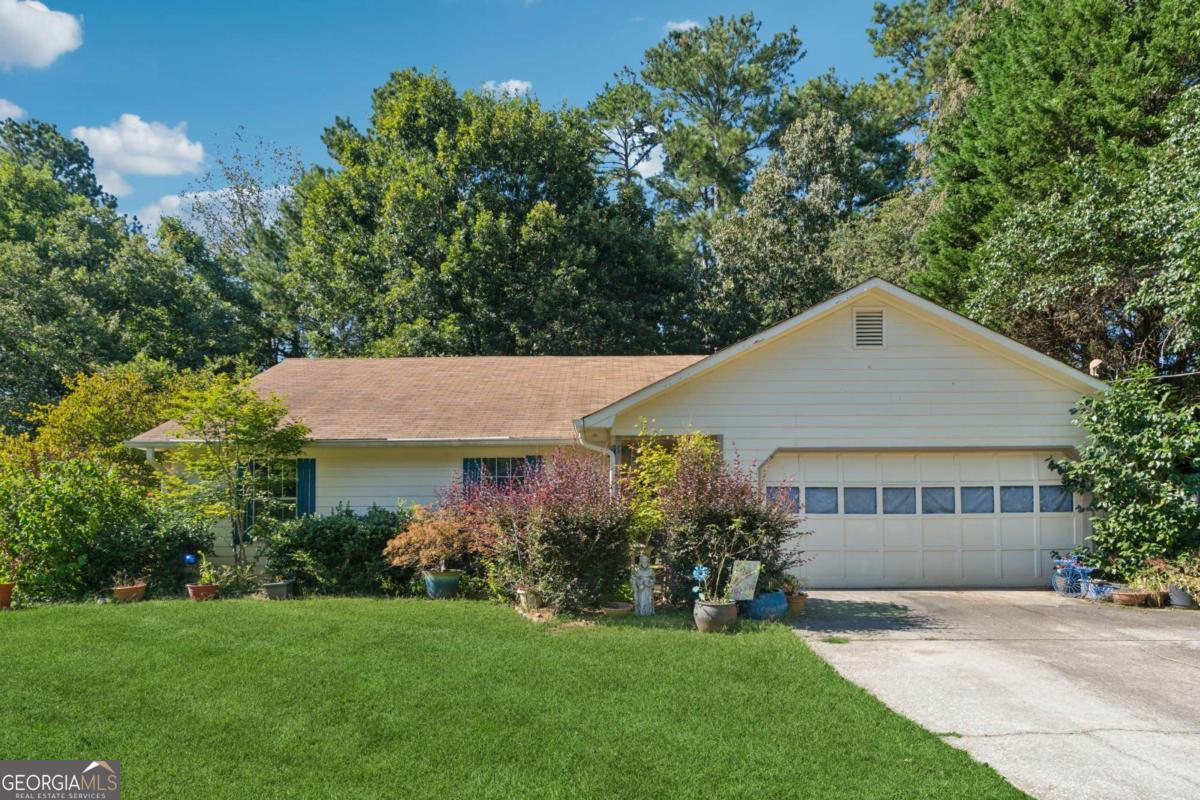 Welcome to 3101 Ashly Brooke Drive, a warm and inviting single-level ranch home in the heart of Snellville. This charming property offers an ideal opportunity for a first-time buyer, someone looking to downsize, or an investor seeking a solid home with room to add value. Greeted by a large open living area featuring soaring vaulted ceilings and a beautiful stone fireplace that immediately creates a cozy yet spacious atmosphere. Natural light pours through the windows and sliding doors, highlighting the generous floor plan and giving the home an airy feel. The open dining space connects the kitchen. Three comfortable bedrooms and two full bathrooms provide plenty of room for family and guests. The expansive primary suite features a private bathroom with a large vanity, walk-in shower and tub combo, and extra storage, while the secondary bedrooms are perfect for children, guests, or a home office. A dedicated laundry area. Beyond the interior, the backyard offers a peaceful retreat with mature shade trees, a patio area for entertaining, and ample space to garden, play, or create your own outdoor oasis. It's a yard that invites you to envision cookouts, children's play, or a vegetable garden under the Georgia sun. The home places you minutes from everyday conveniences and popular destinations such as schools, medical facilities, and major roads. This is a great but for personal or investor use. Home could use some TLC and price reflects that.