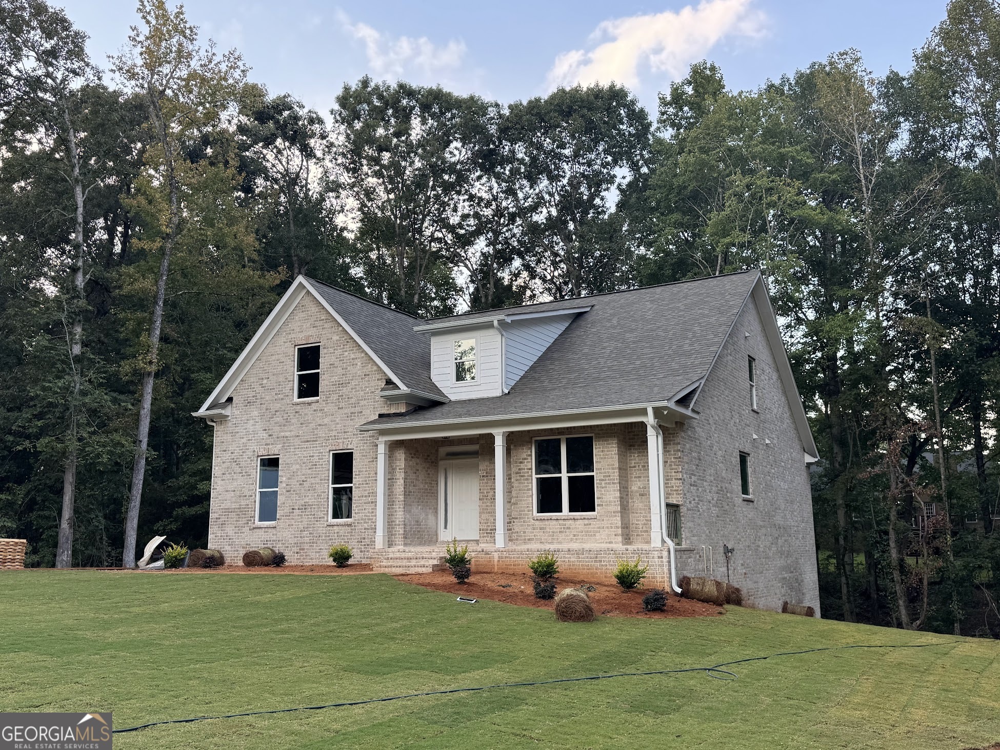 New Home on a full basement in a great neighborhood! $15K Incentive with a preferred lender! All Brick 4 Bedrooms (primary on main floor), 3 Full Bathrooms, 1 half bath in an open concept floorplan with side entry garage on a large wooded 3 acre lot, home is tucked in with trees all around for privacy. Walk in to the 2-story foyer that leads to the massive great room with soaring ceilings and a masonry fireplace (gas starter), open to spacious kitchen with large island and dining space. The kitchen features corner pantry, bright white soft-close cabinetry, granite countertops and stainless steel appliances. Beautiful black lighting, plumbing fixtures and hardware. The dining room leads to outdoor deck overlooking your private wooded lot. Upgraded SPC wood plank flooring throughout the home. The primary suite is on the main level and has a tray ceiling, large bathroom, granite countertops, dual vanity, separate tile shower and massive walk-in closet. Large laundry room and convenient half bath on the main floor. Upstairs you'll find 3 bedrooms and 2 full bathrooms. This large lot is 3 acres of peaceful wooded privacy with a creek that runs through the back yard. Home is Under Construction- 95% complete