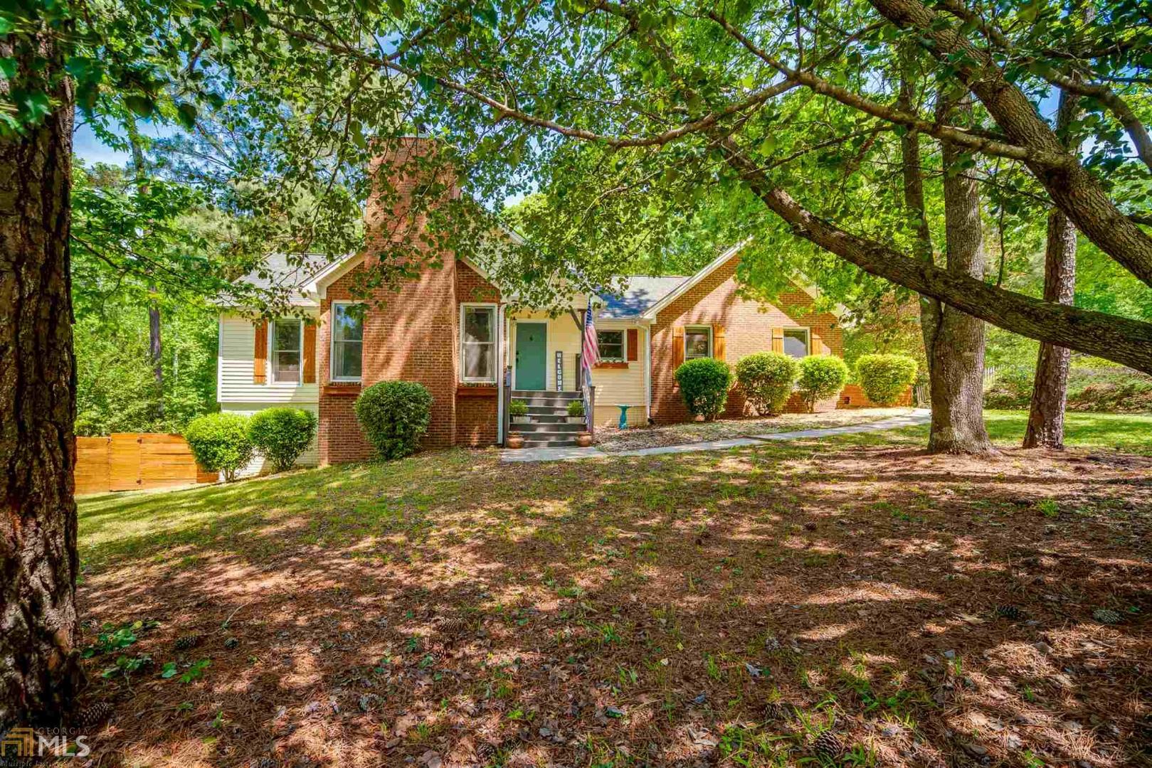 Renovated RANCH home w/ tons of character from custom built cabinetry to shiplap walls. Hardwood floors throughout the main. Floor to ceiling brick fireplace w/ custom built mantle & vaulted ceiling in great room. Master suite features his/her closets, barnwood panel wall w/ barn door to bathroom, double vanity w/ granite counter tops & oversized walk-in tile shower w/ dual shower head. Kitchen is equipped w/ stainless steel appliances, tile backsplash & LED recessed lighting. Ceiling fans & vaulted ceiling in secondary bedrooms. Full bathroom, bedroom, office & large rec space in basement. Private, fenced backyard w/ green house, storage building & custom hexagon swing set. Convenient to I-85, Peachtree City, shopping & restaurants.