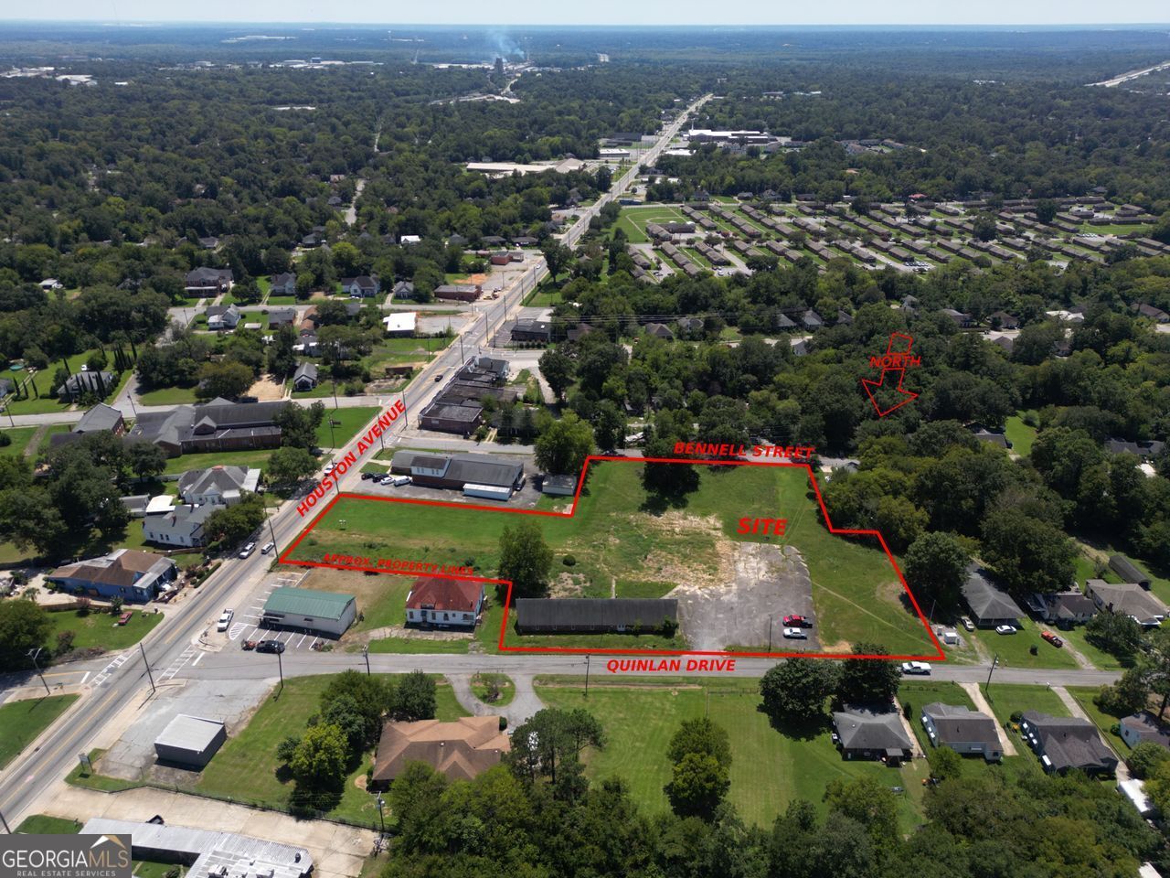 BUILDING with Commercial acreage to grow & (3) separate road frontages. Close to I-75 access. Property access on Quinlan Drive with 359' of road frontage. Other road frontages are 130' on Houston Avenue and 226' on Bennell Street. Road frontages dimensions are approximate. Four-sided brick building with 3,451 sq. ft. has several office-sized rooms and a large hall area with (2) half baths. A cleared site is present where a church used to be. Priced to sell!
