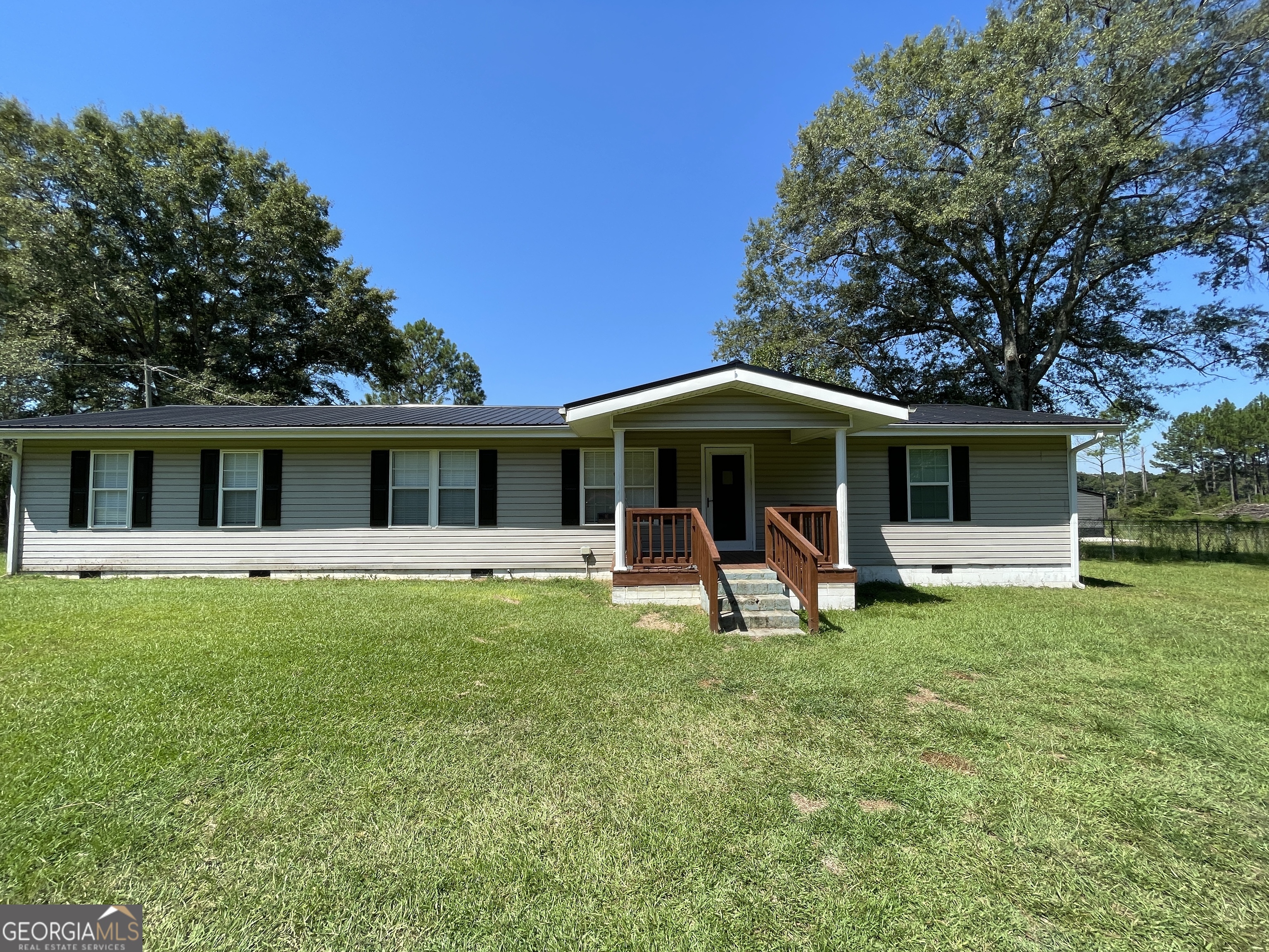The stick built home has been recently completely remodeled (2024). Updated with new flooring, new kitchen cabinets and granite counter tops. Home has new bathrooms. Home features open floor plan with spacious kitchen with a kitchen island perfect for entertaining. Owners suite has attached bath and walk in closet. Secondary bedroom are spacious enough for queen size beds. Home sits on 3.57 acres of unrestricted land. Large metal building (30 X 40) built in 2024. Property features fenced in area for pets. Lots of privacy with few neighbors. Looking for privacy and no city taxes? Look no further.