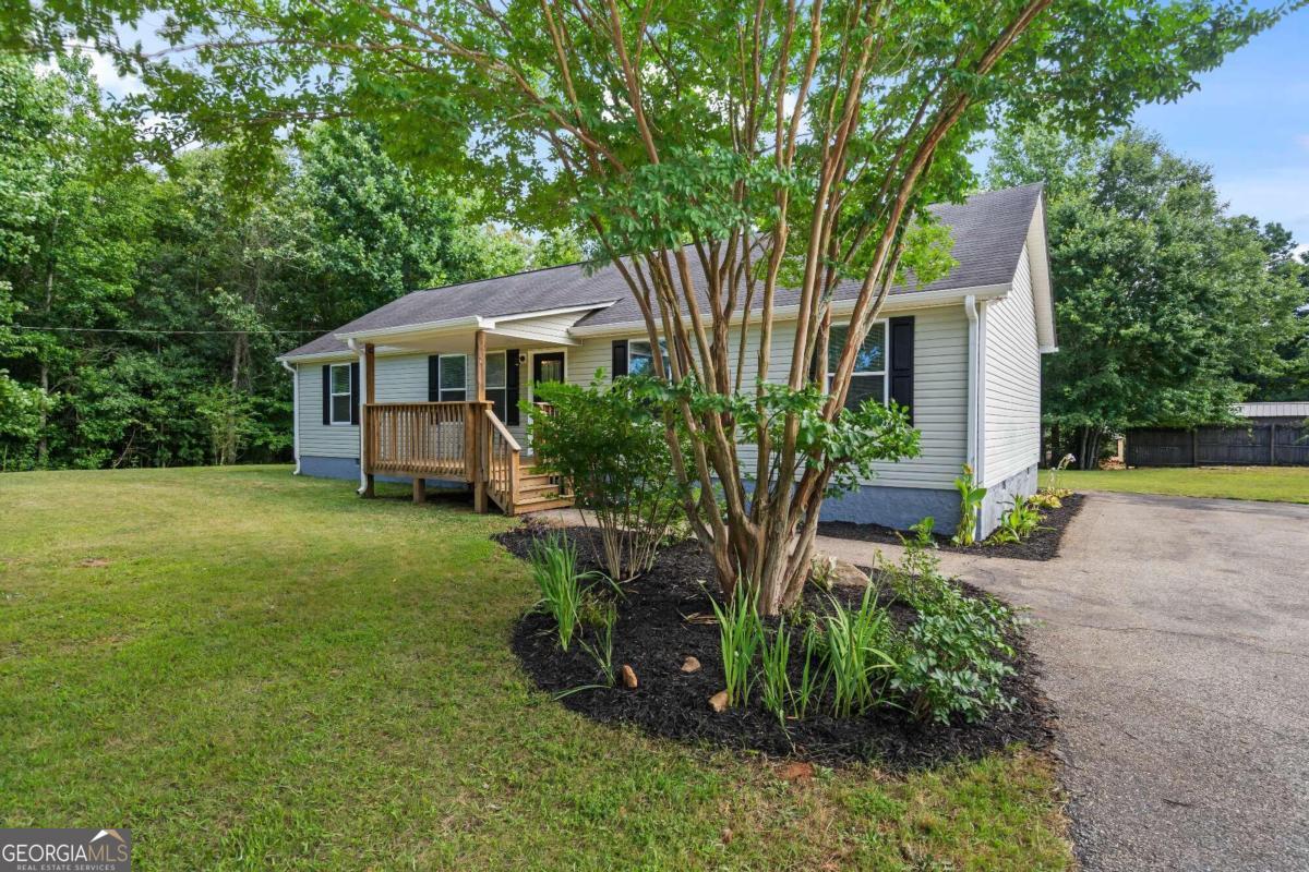This is an amazing home nestled in the coveted Lumpkin/Hall area! This charming residence boasts 4 bedrooms and 2 bathrooms on an expansive 1.51-acre lot. Inside, you'll find a spacious living/dining area complemented by a cozy breakfast nook and a generously sized open kitchen equipped with nice stainless appliances, perfect for entertaining and daily living. Outside, the large yard offers endless possibilities for outdoor activities and relaxation. Brand new floors, paint, and water heater makes this home a fantastic opportunity with nothing needed, it has a remarkable value at a competitive price point. With no HOA fees, seize this rare chance to own a piece of paradise in a prime location. Act fast this one won't stay on the market for long!