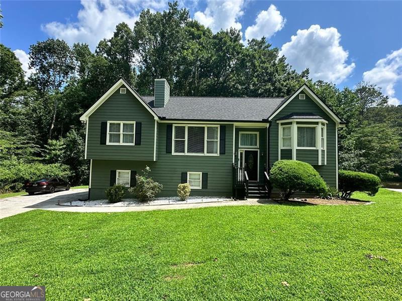 Located in desirable Conyers, this spacious home offers nearly 1,900 sq ft with 4 bedrooms and 3 baths, featuring a stylish kitchen with granite countertops and stainless steel appliances, an architectural accent wall and fireplace in the family room, and vaulted ceilings in the oversized primary suite complete with a bay window, large walk-in closet, and a luxurious bath boasting a soaking tub, separate shower, and dual vanities. The versatile layout includes a guest bedroom and bath, a Jack-and-Jill bath for secondary bedrooms, and a finished basement with a massive laundry room, full bath, fourth bedroom, and ample storage. Enjoy outdoor living on the new two-tier deck overlooking serene lake views and a wooded backdrop. Additional highlights include a new roof, new HVAC and AC unit, gutter guards, landscaped yard, and built-in garage storage with an opener.