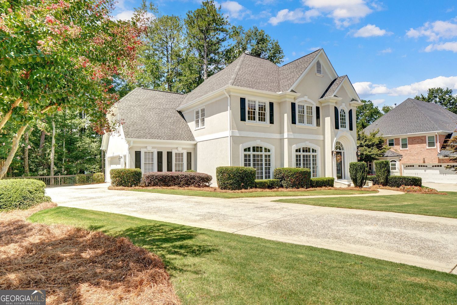 Discover refined living in this beautifully crafted hard coat stucco home, nestled in sought-after Dunmoor. Arched windows, custom lighting, and detailed millwork elevate the home's architectural charm. Inside, you'll find gleaming hardwood floors, soaring ceilings, and a two-story Great Room filled with natural light. The layout offers 5 bedrooms and 4 baths, including a main-level guest suite. The spacious kitchen features stainless steel appliances, a gas cooktop, walk-in pantry, and an inviting breakfast area. Retreat to the oversized primary suite with spa-style bath, updated shower, dual vanities, and generous closet space. Upstairs, two bedrooms share a Jack-and-Jill bath with extra hallway storage. The finished terrace level offers versatile living with a full second kitchen and washer/dryer ideal for in-laws or guests, a large Rec Room with fireplace and bedroom, a newly finished two extra two room for office, full bath, screened porch, and patio. Additional upgrades include new carpet, tankless water heater, whole-house fan, irrigation system, roof with architectural shingles, and gutter guards. Dunmoor offers exceptional amenities-pool, tennis courts, playground, and clubhouse-all just minutes from GA-400, Avalon, Perimeter Mall, parks, and local shops. A warm, welcoming home with flexible spaces and timeless charm-schedule your tour today!!