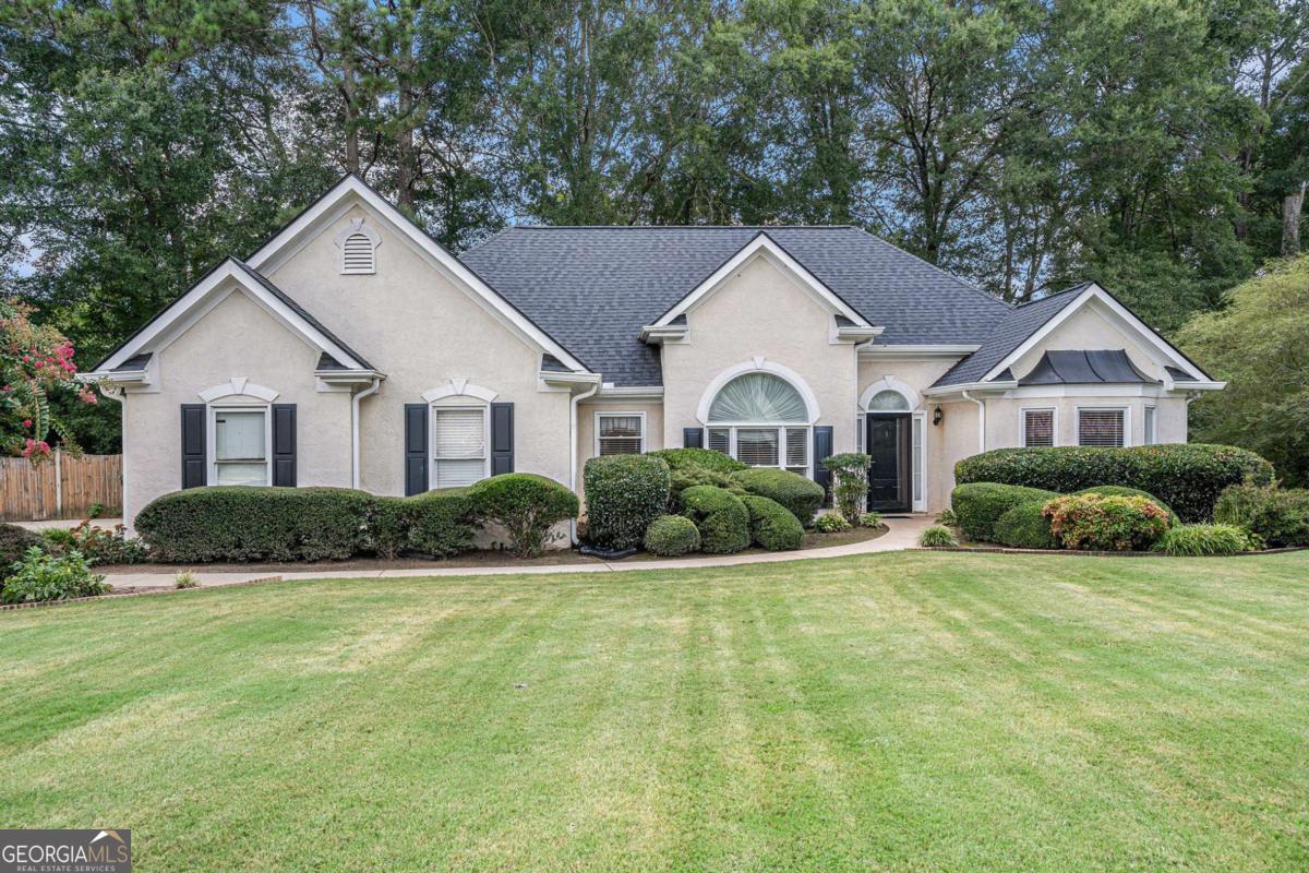 Located in the desirable Wentworth community in Oxford, GA, this charming one-story home offers 3 bedrooms, 2 full bathrooms, and convenient access to I-20, daily shopping, and dining. This home has been thoughtfully updated with a brand-new roof, new flooring in the living room, dining room, kitchen, and laundry room, and new gutters, ensuring both beauty and peace of mind for the new owner. Additionally, an air scrubber has been added to the HVAC system, providing cleaner, fresher air throughout the home. The inviting living room features elegant double tray ceilings and a cozy fireplace, creating a warm and open gathering space. The kitchen and dining area flow together seamlessly, with a breakfast bar and direct views into the living room-ideal for both everyday living and entertaining. The kitchen also provides easy access to the walk-in laundry room and attached garage. The primary suite is thoughtfully positioned on one side of the home for added privacy and features dual sinks, a soaking tub, separate shower, and a spacious walk-in closet. Two secondary bedrooms are located on the opposite side, along with a full bathroom that includes a tub/shower combo. Enjoy outdoor living in the screened back porch and additional open patio space, perfect for relaxing or entertaining. The fenced backyard includes a storage shed and plenty of room for play, gardening, or pets. Don't miss out on this well-maintained home in a great location-schedule your tour today! Discounted rate options and no lender fee future refinancing may be available for qualified buyers of this home.