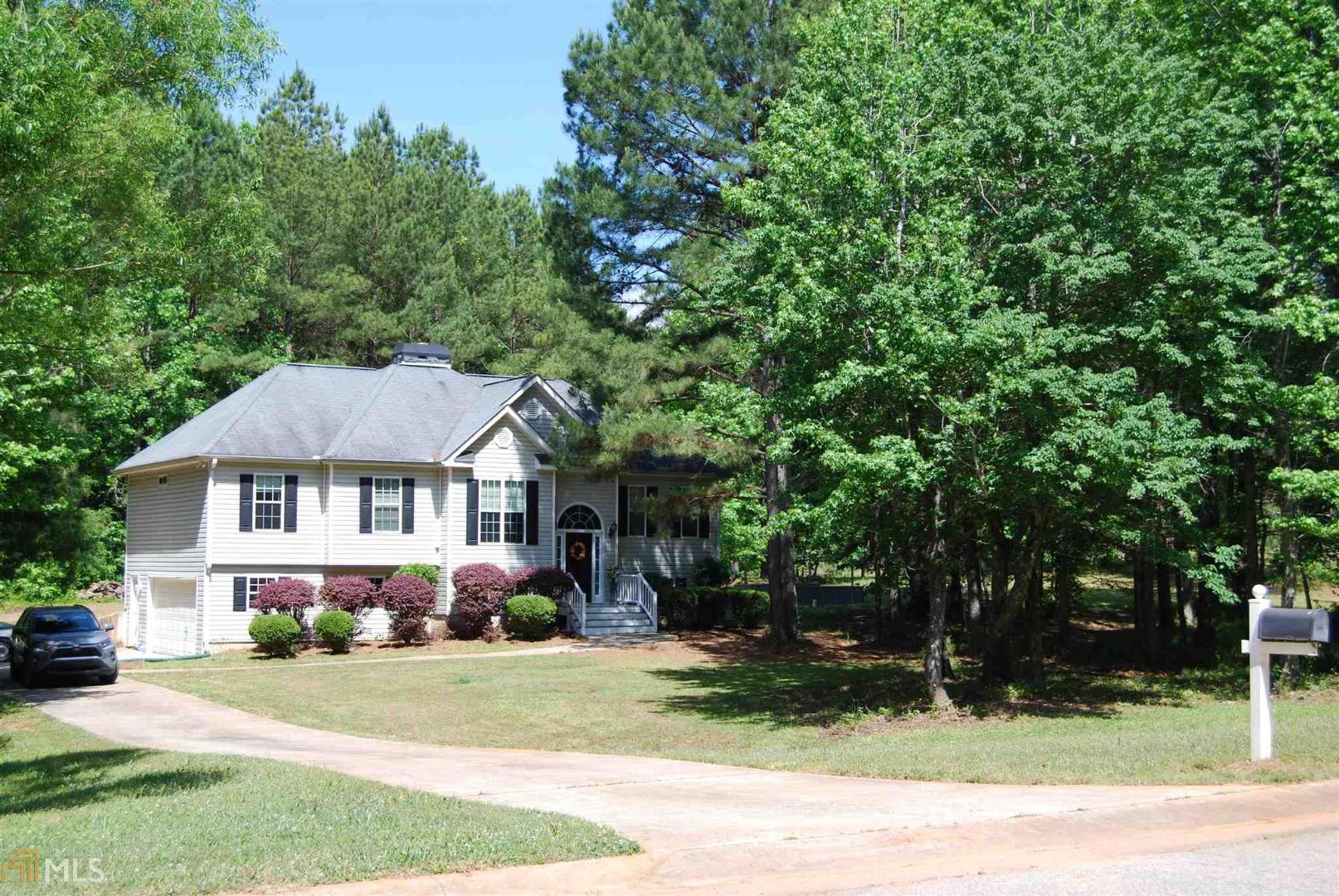 MOTIVATED SELLER! PRICE REDUCED 10K ! Private 2 acre lot sanctuary in Pike County in the beautiful Irish Hills Subdivision. Large family room with stacked stone wood burning fireplace, separate dining room, and open kitchen with breakfast area and bar. Split bedroom plan offers large master with walk in closet and separate garden tub and shower. On the opposite side of the home you will find two nice sized bedrooms and a full bath. Downstairs you will find newly finished spaces that can be used as an additional family/rec room and possible additional bedroom. A full bathroom is stubbed and waiting for the finishing touches. Relax on the back covered porch just off the family room and enjoy the serenity of the tree lined private backyard. 2 large raised planters will house a bountiful harvest for the coming year. Newer well and septic system with septic pump to combat those fierce Georgia rain storms. Air conditioning was recently serviced on 6/10/2020. Seller to offer $200 concession at closing for microwave.