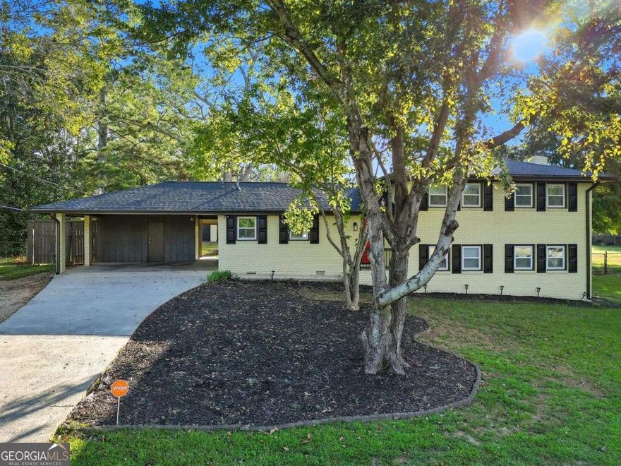 Welcome to instant equity in this beautifully renovated 4-bed, 3-bath split-level traditional home! Every detail has been thoughtfully updated to combine modern luxury with timeless charm. Recent upgrades include all-new plumbing, electrical, roof, and flooring throughout, giving you peace of mind for years to come. The heart of the home is the entertainer's kitchen, featuring custom cabinetry, sleek quartz countertops, a large island, and stainless-steel appliances. This open-concept space flows effortlessly into the spacious living area and covered patio, creating the perfect environment for both everyday living and gatherings with family and friends. Upstairs, the Primary Suite is your private retreat with a luxurious ensuite bath complete with a double vanity and a jetted rainfall shower. The secondary bedrooms are generously sized and share a beautifully updated full bath. The terrace level offers incredible versatility with a private in-law suite, including a bedroom, full bath, and a cozy fireside den/dining area-ideal for guests, multi-generational living, or even rental income. For storage and hobbies, this home features a 2-car carport plus a 24x28 detached finished garage/workshop. The workshop is already wired and finished, making it ready to be transformed into a modern content studio, home office, or additional income-producing space. Located in a quiet, no-HOA community with low Cobb County taxes, this property not only offers comfort and flexibility but has also been successfully used as a profitable short-term rental investment. Don't miss this opportunity to own a move-in ready home that truly has it all. Schedule your private showing today!