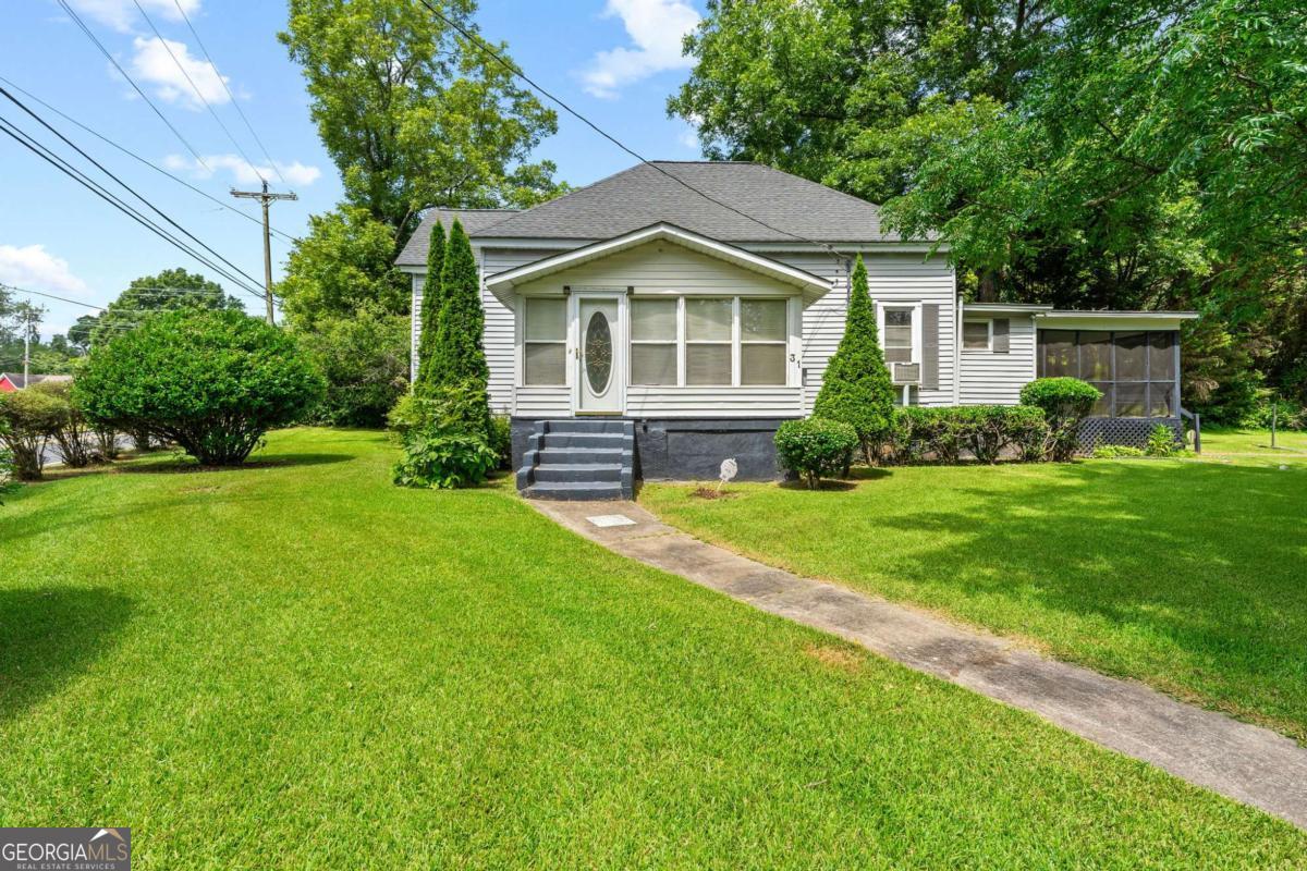 Investor Special with Tons of Potential! Bring your vision to 31 Elm Street in Hampton, Georgia! This property offers great bones and sits on a beautiful lot featuring mature pear, fig, and pecan trees-a rare find! With new construction homes starting in the mid-$300s directly across the street, this is a prime opportunity to renovate and add significant value. Whether you're looking to fix and flip or hold as a rental, this property is positioned perfectly for a solid return on investment. Don't miss this chance to capitalize on Hampton's growing market!
