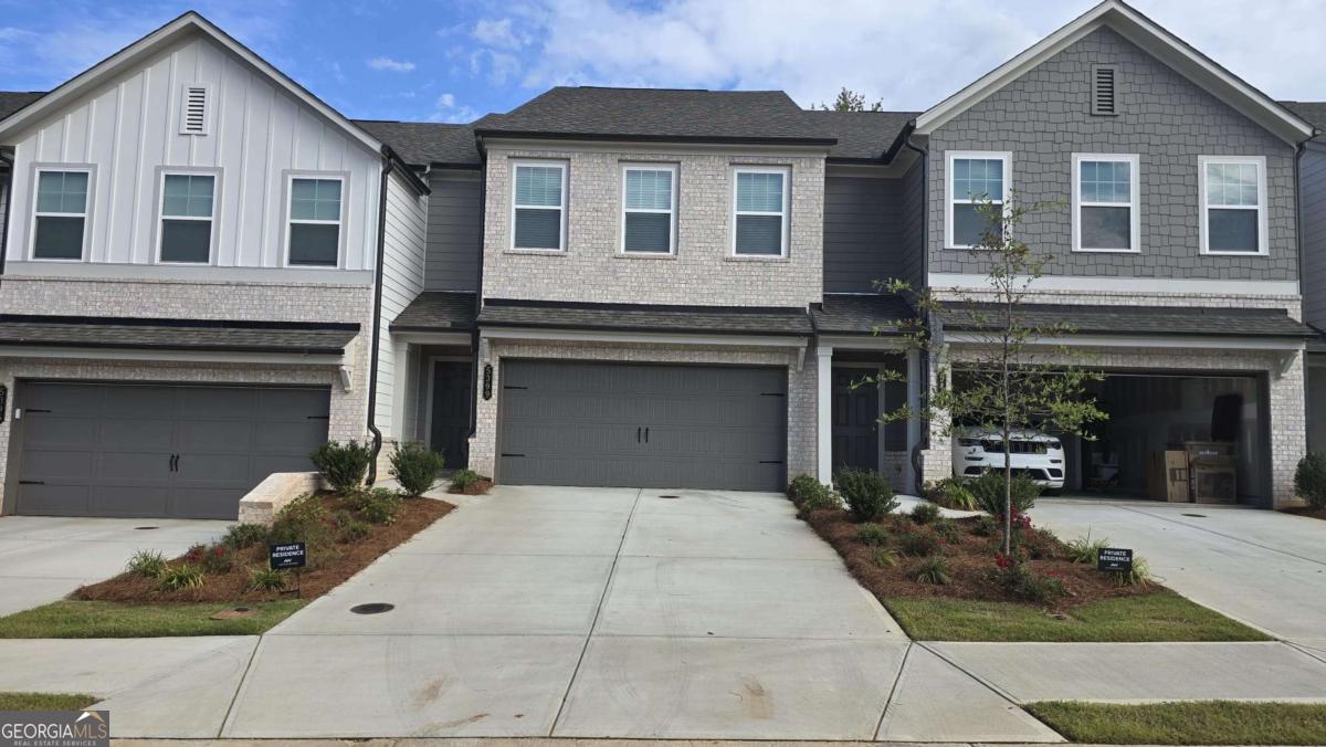 Spacious 3 bed / 2.5 bath Marigold plan townhome with 1,800 sq. ft. of living space and a 2-car garage with full driveway. Open main level features a family room, dining area, and modern kitchen with painted cabinets, large island, quartz countertops, backsplash, and stainless appliances. Covered patio off dining area is perfect for relaxing. Upstairs includes a large primary suite with walk-in closet, double vanities, and walk-in shower. Two additional bedrooms, a full bath, and laundry room complete the upper level. Located in Eastlyn Crossing, a vibrant community with pool, cabanas, and pickleball courts. Convenient to Lake Lanier, historic downtown Flowery Branch, parks, shopping, and dining.