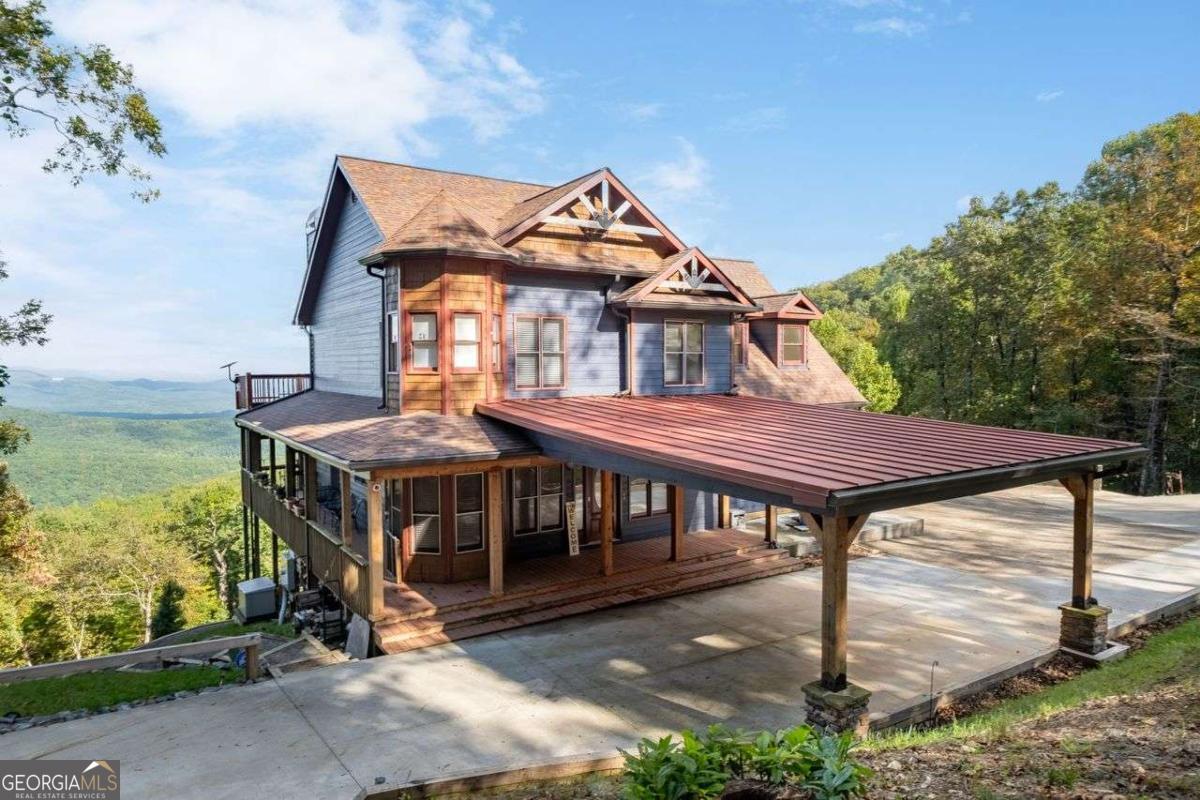 JUST APPRAISED! PRICED BELOW APPRAISED VALUE! Unparalleled mountain views await you! Imagine waking up to panoramic vistas that stretch across the majestic Blue Ridge Mountains, reaching as far as North Carolina and Tennessee. This exceptional property offers the ultimate in unrestricted mountain living, easily accessible via paved roads, and with the option to expand your estate by purchasing additional acreage. It's a rare opportunity to own what might be the best views on this side of the Blue Ridge Mountains. From any of the three private decks, take in awe-inspiring, long-range views spanning over 50 miles-breathtaking in every season. Unwind in the private spa, complete with an automatic cover, and let the serenity of nature surround you. This property invites you to enjoy the sights and sounds of native hummingbirds and abundant wildlife right at your doorstep. The home has been thoughtfully updated with fresh exterior paint, a new generator, and a remodeled basement featuring a custom Murphy bed-perfect for guests. For those looking to expand, architectural plans are ready, allowing the home to grow up to 7 bedrooms with a newly installed septic system featuring two tanks. This property would be an incredible venue for events, short or long-term rental or even for use as a hunting lodge. The custom-built "workshop" includes a brand-new bathroom, offering the potential for additional living space or even a rental unit. Whether you need a creative studio, guest suite, or income property, the possibilities are endless. Located near Jasper, Georgia-celebrated as the First Mountain Town-this property offers the perfect blend of tranquility and convenience. Just an hour from Atlanta, you can enjoy the area's charming atmosphere, exquisite dining, local vineyards, and luxury resorts. Outdoor enthusiasts will love the nearby hiking trails. The main house sits on 6 private acres, with the option to expand with newly subdivided land parcels next door. Whether you're looking for a serene getaway, a forever home, or an investment opportunity, this property offers it all. Don't Miss Out-Schedule Your Private Tour Today! This is more than just a home; it's a lifestyle. Secure your piece of mountain living and schedule your tour today and experience these stunning views for yourself!
