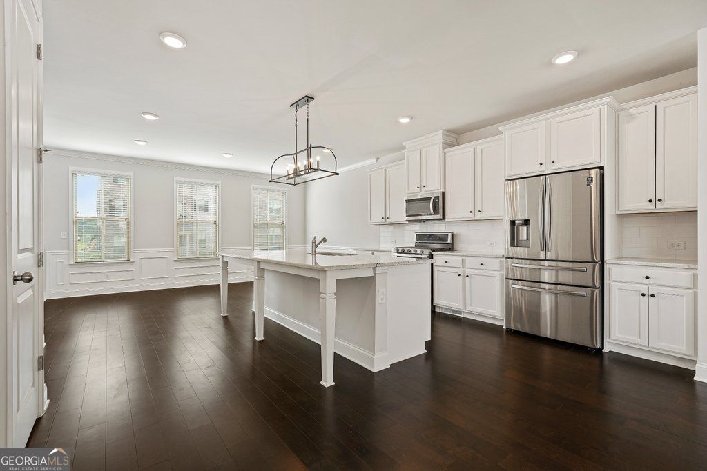 AVAILABLE AUGUST 31, 2025. END UNIT. Built in 2021, this luxury townhome features brand new carpet in the bedrooms, professionally cleaned interiors, and refreshed walls with paint touch-ups underway to keep the space bright and well cared for-fully move-in ready at the end of August! Hardwood flooring throughout, apart from the bedrooms. Gated community near the Perimeter/Dunwoody area. Quick & easy access to the Perimeter Mall area, Sandy Springs, Buckhead, Peachtree Corners, etc. Next to Highway I-285 & 141, short distance to SR 400. This modern 4 bedroom, 3 & a half bath home consists of a 3-level design, that includes an Open Floor Plan, complete with 10' ceilings, crown molding, recess lighting throughout. Features a Gourmet Kitchen with an enormous center island, 42' cabinets throughout, granite countertops & subway backsplash, stainless steel appliances, & a walk-in pantry room, designer linear fireplace in the Family Room. There is a private deck off the back of the unit, perfect for relaxing or outdoor dining; the deck was pressure washed recently as well. Spacious primary bedroom with a large walk-in closet, double vanities, large shower. Upstairs also consists of 2 additional bedrooms with upgraded bathrooms & walk-in closets. The laundry room includes extra shelves for added convenience. The terrace level is complete with a full bedroom that can be used as a guest suite/flex space/bonus room with a large walk-in closet & full bathroom. Enjoy amenities - resort style pool, six private cabanas, grilling area, corn hole area, playground, firepit, community parks nearby. Wide streets, plenty of designated on-street guest parking. Carver Hills subdivision is also conveniently close to Assembly Studios Atlanta, Farmers Market, H Mart, local shopping and dining at The Forum on Peachtree Parkway, Perimeter Mall. Also, close proximity to Corporate offices for State Farm, Mercedes Benz, and IHG. Dunwoody High School District.