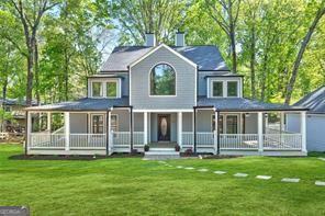 Discover the pinnacle of luxury living in the prestigious Berkeley Lake, just steps from the tranquil shoreline. Perfectly situated on a commanding corner lot with lush, sweeping land surrounding the property, this fully renovated residence delivers the perfect blend of timeless elegance, expansive space, and unparalleled privacy-all within one of Georgia's most sought-after and top-rated communities. This stunning 6-bedroom, 4-bathroom residence spans over 5,000 square feet and has been meticulously redesigned and completely renovated with high-end finishes and sophisticated modern touches. From the gleaming new floors, new lights, new kitchen, all new bathrooms, and new interior & exterior paint to the abundance of other upgrades, every detail reflects true craftsmanship and care. Step inside to find grand, open-concept living areas anchored by a beautifully crafted stone fireplace, adding warmth, character and architectural interest. Expansive living rooms provide exceptional flow and lead effortlessly to the sprawling rear decks and stately wrap-around porch, ideal for seamless indoor-outdoor living. The heart of the home is the state-of-the-art chef's kitchen, showcasing custom shaker cabinetry, quartz countertops, stainless steel appliances, stunning backplash, and a well situated island. Mulitple dining areas in the home offer additional room perfect for both casual meals and elevated entertaining for guests. The primary suite is a luxurious retreat, featuring abundant closet space, two separate sitting areas, and a spa-like bathroom with a glass-enclosed shower, soaking tub, LED mirror, and polished porcelain tiles. Upstairs, generously sized secondary bedrooms offer soaring ceilings, individual sitting areas, and access to a shared enclosed balcony, creating serene personal sanctuaries. A third-floor bonus room offers ultimate flexibility-perfect as a playroom, home office, or creative studio. Back on the main level, a private guest suite with direct access to the porch ensures comfort and convenience for long-term guests or multigenerational living. The daylight-finished basement extends the living space with a large living area, additional bedroom, full bathroom, ample storage, and an extra room for a home theater or fitness center. Set on over 0.70 acres of beautifully manicured grounds and yard, this home boasts four separate decks and a gracious wrap-around porch-offering multiple spaces to relax, entertain, and soak in the peaceful surroundings of this idyllic community. This is more than a home-it's an elevated lifestyle in one of Georgia's most exclusive lake neighborhoods. A truly rare and turn-key home that offers refined luxury, privacy, and unmatched charm. Home is virtually staged. Home is also available for rent.