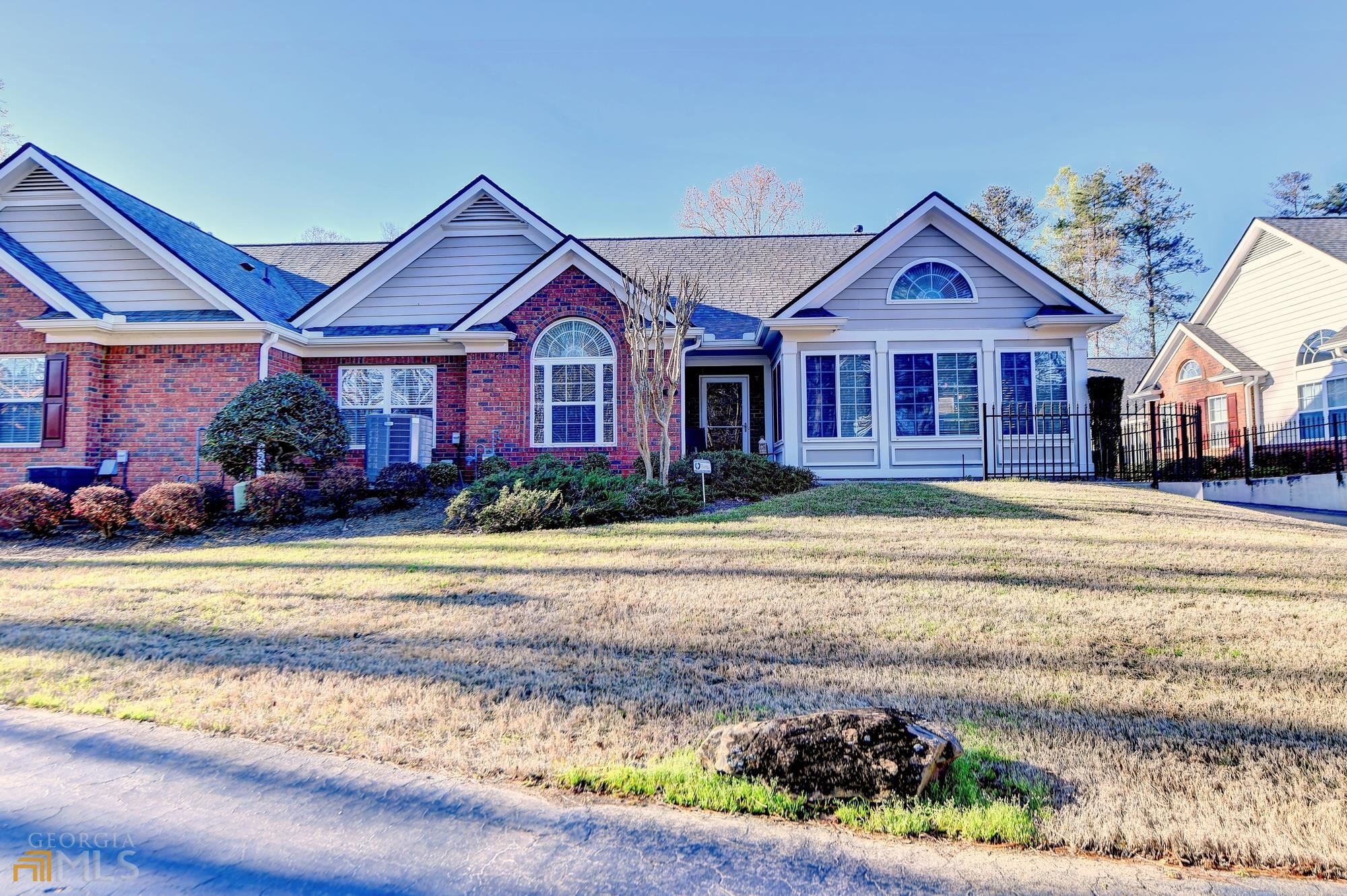 MAINTENANCE FREE RANCH CONDO W/COMMUNITY CLUBHOUSE, FITNESS CENTER & S/POOL. BEST LOCATION IN COMMUNITY-RIGHT ACROSS FROM CLUBHOUSE & OFF MAIN ROADWAY. 3 FUNCTIONAL BEDROOMS. BEAUTIFUL BRAZILIAN CHERRY H'WOODS THROUGHOUT; NO CARPETING. BRIGHT SUNNY SUNROOM W/WINDOWS ALL AROUND & VIEW OF WOODED AREA. KITCHEN W/CORIAN C/TOPS & UPGRADED STAINLESS STEEL APPLIANCES. EASY ACCESS TO I-85, HWY 316, SHOPPING, MEDICAL FACILITIES. SECURITY SYSTEM OWNED. LOTS OF UPGRADES!