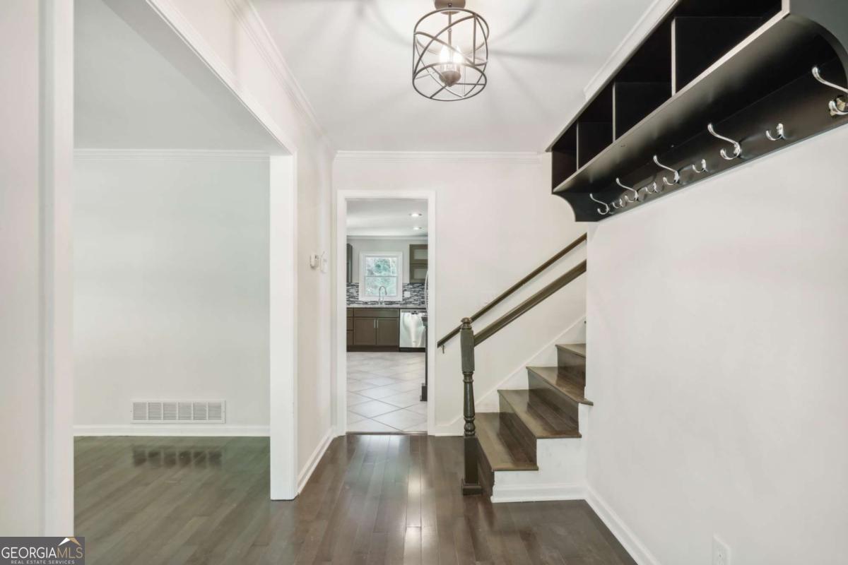WELCOME TO 4935 CAMBRIDGE DRIVE - A BEAUTIFULLY UPGRADED SPLIT-LEVEL GEM IN THE HEART OF DUNWOODY! Tucked into the highly sought-after Cambridge Estates community, this spacious and stylish 4-bedroom, 3-bath home offers the perfect balance of comfort, modern upgrades, and LOCATION! Just minutes from Perimeter Mall, top-rated schools, parks, and major highways, convenience meets charm in this move-in-ready home. Step inside to a welcoming foyer that opens to a bright and airy living room, leading into the beautifully updated kitchen featuring white shaker cabinets, granite countertops, stainless steel appliances, a breakfast bar, and elegant tile backsplash. The adjoining dining area flows seamlessly into the lower-level family room-perfect for entertaining-with access to a PRIVATE BACKYARD PATIO retreat. The lower level also features a guest bedroom and FULLY RENOVATED BATHROOM-ideal for visitors, home office, or multi-generational living. Down one more level, you'll find a FINISHED BASEMENT/FLEX ROOM with endless possibilities: fitness studio, playroom, or bonus storage. Upstairs, the OWNER'S SUITE includes a renovated ensuite bath with modern fixtures and finishes. Two additional generously sized bedrooms share a beautifully updated full bath with double vanities and custom tilework. Other highlights include: gleaming hardwood floors, recessed lighting, an OVERSIZED GARAGE with WORKSHOP SPACE, a NEW ROOF (2021), and lush landscaping offering curb appeal and privacy. Whether you're hosting gatherings or enjoying quiet evenings at home, this layout suits every lifestyle. This is your chance to be an tenant in a thoughtfully updated home in one of Dunwoody's best locations-schedule your private showing today!