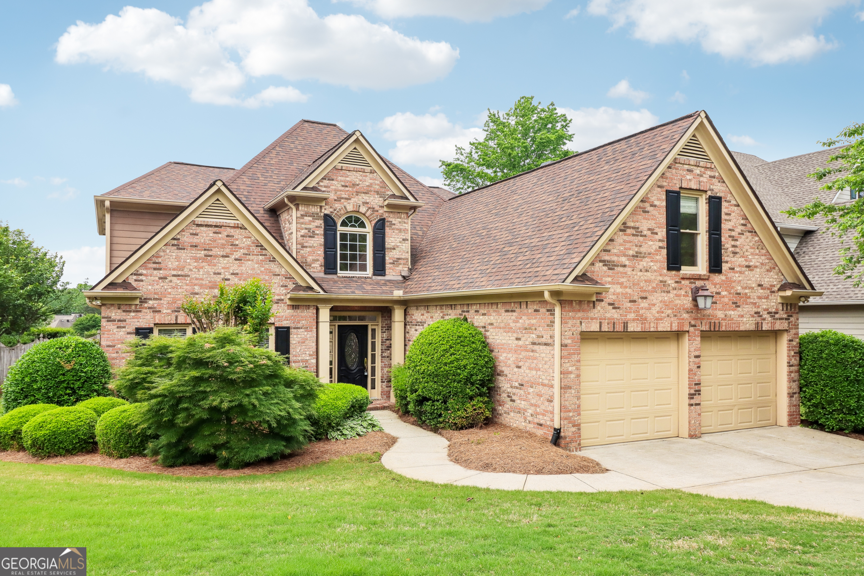 **PRIMARY ON MAIN**Welcome to this beautifully maintained brick home situated on a corner lot in a highly desirable Marietta community. Ideally located near top-rated schools, shopping, dining, healthcare, and all the best of Marietta. This home also offers easy access to major highways for a smooth commute and beyond. Enjoy resort-style amenities just in time for summer, including a community pool, tennis courts, and a playground for year-round enjoyment. The home's exterior impresses with favorable color tones, a lush lawn, covered front entry, and a two-car garage with separate doors, all contributing to exceptional curb appeal. Step into a bright and welcoming two-story foyer with views of the elegant staircase and catwalk, bathed in natural light from the large palladium window. The formal dining room flows into a spacious eat-in kitchen, featuring sleek black granite countertops, ample cabinetry, a breakfast bar, and an additional dining area. The kitchen also includes stainless steel appliances, a double wall oven, gas cooktop, and more, perfect for preparing meals and entertaining. Adjoining the kitchen, the keeping room offers a cozy, informal space to relax and unwind. Continuing the effortless flow from room to room, the two-story family room boasts a fire place and vaulted ceilings. The main-level primary suite showcases a double tray ceiling, patio access, a double vanity with makeup counter, walk-in shower, jetted tub, and a custom closet system for optimal organization. Upstairs, you'll find a secondary en-suite bedroom with a soaking tub and separate shower, plus two additional bedrooms and another full bathroom, providing comfort and privacy for family or guests. Step outside to a garden-inspired backyard oasis, complete with a stone water feature, river rock fire pit, and a flagstone patio with retaining wall seating, the perfect backdrop for evening gatherings and tranquil weekends at home. This home offers the perfect balance of luxury, function, and location, making it a must-see for anyone looking to enjoy the best of Marietta living.