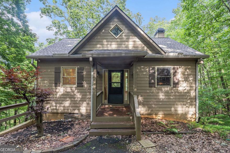 Discover mountain living at its finest in this beautiful 3-bedroom, 2.5-bathroom home, perfectly situated on a quiet cul-desac in the prestigious Big Canoe community. Set against the backdrop of the stunning Blue Ridge Mountains, this home  offers year-round mountain views, peaceful privacy, and a floor plan designed for comfort and entertaining.  Step into the inviting open-concept main level, where soaring ceilings and windows flood the space with natural light and  frame breathtaking views of the surrounding forested landscape. The family room flows seamlessly into the kitchen and  dining area, making it ideal for hosting guests or enjoying quiet evenings by the fire.  The chef's kitchen features rich stained cabinetry, granite countertops, a breakfast bar, and stainless steel appliances,  including a gas range-perfect for preparing meals while enjoying the serene wooded views. A dedicated dining space  just off the kitchen provides room for both everyday dining and special gatherings.  The primary suite on the main level offers a peaceful retreat with a walk-in closet and an ensuite bathroom featuring a  jetted soaking tub. Step outside to the main level deck, an ideal space to sip morning coffee or unwind while soaking in  the panoramic mountain scenery.  Downstairs, the finished level offers two additional bedrooms, a full bath, and a large bonus room perfect for a second  living area, home office, or media room. The covered and screened-in lower porch provides another serene space to  relax, enjoy the outdoors, or entertain rain or shine.  This home is nestled within Big Canoe, a one-of-a-kind private, gated mountain community that offers something for  everyone: over 20 miles of hiking trails, three pristine lakes, three waterfalls, 27 holes of championship golf, a full-service  marina, tennis and pickleball courts, a wellness center, swimming pools, and more than 50 active clubs and social events.  Located just over an hour from Atlanta, this community blends resort-style living with small-town charm. Whether you're  looking for a primary residence, vacation home, or investment property, this mountain oasis is not to be missed.