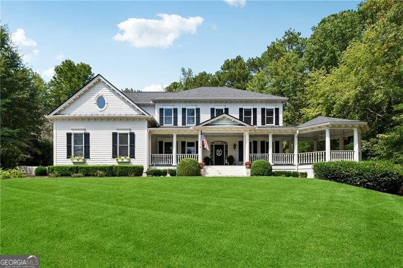 Southern Charm abounds here at 330 Galloway View in sought-after White Columns! Perfectly situated on -/+ 1.41 acres, one of the prettiest and largest lots in the neighborhood. Perched in a cul-de-sac with a walkout backyard, porches galore and a dreamy pool, you'll feel like you're on vacation every day! Entering the foyer, you are welcomed by authentic hardwood floors, higher ceilings and a traditional dining room with custom built-ins. Across the center hall foyer is a beautiful living room with coffered ceilings. Continue down the hall to the family room with 3 sets of french doors overlooking the covered back porch and looking over into the kitchen. The kitchen offers a generously sized Viking gas range, solid surface counters, farmhouse sink, backsplash and lighted cabinets to the ceiling. A custom-built buffet server and butler's pantry are convenient for storage and serving drinks and coffee. Walk out to the back porch and you are welcomed by an incredible on-grade yard overlooking a heated saltwater pebbletec pool with swim up bar, a pool pavilion with sitting area, fireplace, kitchen and grilling! High end marble coping surrounds this showpiece and a sizeable yard to play in. Upstairs houses the spacious Primary Suite with sitting room, an en suite bedroom, and two others that share a jack n jill bath. In the terrace level, you'll enjoy a media room, kitchenette, family room with fireplace, and a flex/bedroom with a full bath. Walk right out the side door and you can access the side and backyard from the terrace, as well as additional storage space perfect for lawn equipment and pool floats that stay out of sight. New roof, new windows, and more. Southern charm and heart is evident in every inch of this home, we look forward to welcoming you!