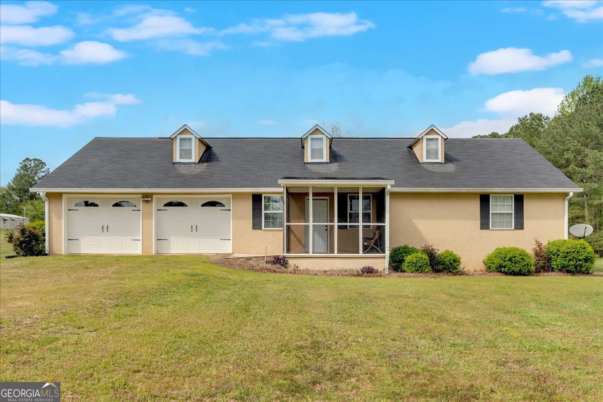 Feel like you are on vacation all the time in this beautiful home featuring an in ground pool right out the back door. The outdoor fireplace lets you sit around the pool from early Spring until late Fall. Inside the home features large living room with open kitchen at one end. Entertaining would be great as everyone including the cook could enjoy being together. Two bedrooms are on one side of the home. Third bedroom on other side of the home could be used as in-law suite or primary bedroom with it's own door to the pool patio. Lots of closets and storage all through the house. Two car garage attached to the home means you never scrape frost off your windshield again or get wet bringing groceries in. Quiet country setting just minutes south of Bowdon.