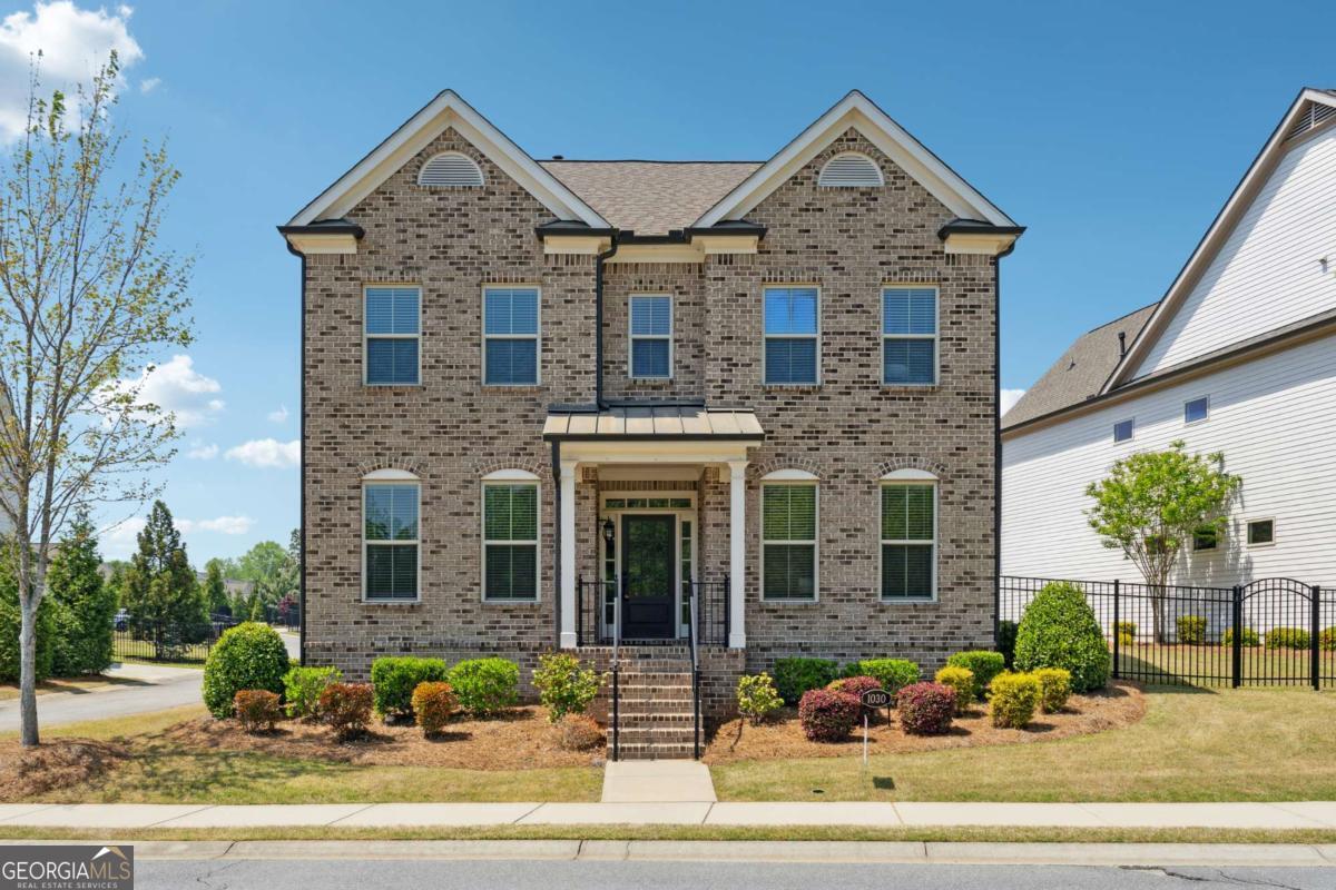 EAST Facing house - Discover a stunning blend of comfort and style in this home nestled in the gated community of Central Park at Deerfield just minutes from Halcyon and all the amenities that Alpharetta has to offer. This nearly newer construction, built in 2018, has everything you want with its open floor plan with custom touches/upgrades throughout. This happy home provides abundant natural light and 10' ceilings all while hosting the largest fenced backyard in the neighborhood. You'll love the seamless flow between dining, entertaining, and cooking in the spacious and bright kitchen. With a main-level bedroom and a full bath, offering privacy and convenience for guests, in addition a separate office space ideal for working from home. Upstairs you will find the oversized primary suite: a true sanctuary with space for a sitting area plus a huge bathroom including double vanity and seamless shower. Tons of storage and closet space. Large secondary bedrooms and separate laundry room conveniently located close to bedrooms. Jack and Jill bathroom upstairs, full backsplash to the ceiling in the kitchen. Quartz kitchen countertop and Marble countertops in all bathrooms. Walking distance to the pool, tennis court and playground, Scenic front view, Jacuzzi in the master bath upstairs and downstairs. Attached 2 car garage, Large fenced side yard. Maintenance-free landscaping, managed by the HOA, ensures you spend more time enjoying life. The community's amenities, include swim/tennis, playground, clubhouse, and 13 acres of green space, catering to outdoor enthusiasts. With sidewalks throughout and walking trails, you can take leisurely strolls through the neighborhood. Yoga studio and dog groomer located steps from the community. You'll have quick access to downtown Alpharetta, Avalon, and Halcyon providing tons of restaurants and shopping.