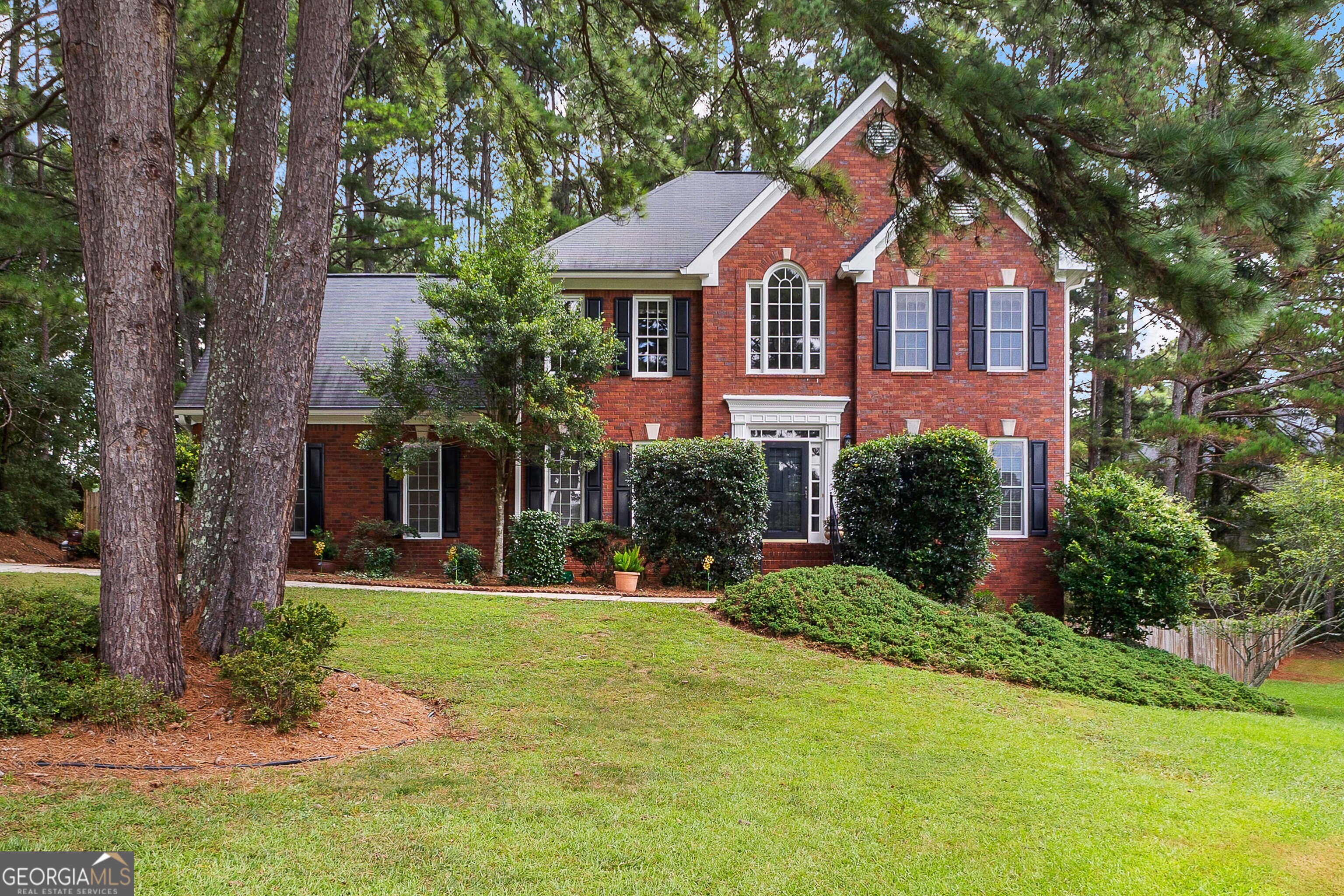 Beautiful Brick Home in Coveted Lakemont Community! Tucked away on a private cul-de-sac lot, this stunning brick home offers the perfect blend of comfort, charm, and convenience. Step into the welcoming open foyer and into a cozy living room featuring a brick fireplace flanked by custom built-in cabinets. The kitchen overlooks a serene backyard and opens to a spacious deck, ideal for entertaining, dining under the stars, or hosting unforgettable outdoor movie nights. Upstairs, the owner's suite offers a peaceful retreat with a soaking tub, separate shower, and two generous closets. Three additional bedrooms with ample closet space share a well-appointed full bath. The full walk-out basement adds incredible versatility, complete with a bedroom, full bathroom, craft or workspace, and two bonus rooms perfect for a gym, media room, or additional storage. Enjoy direct access to Lakemont's incredible amenities: a scenic lake with walking paths, pool, clubhouse, playground, and tennis courts just around the corner via the community sidewalk. All of this located less than 5 minutes from downtown Fayetteville, within the sought-after Whitewater School District, and just moments from Peachtree City. Don't miss your chance to call this home! Your private tour is a phone call away.