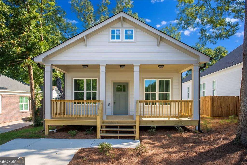 A Craftsman-Style New Construction with Beltline Access. Historic charm up front. Modern comfort inside. An intown address with big potential. This one checks the boxes. Welcome to this new construction home crafted to honor the 1920s Craftsman character. Start on the deep, covered front porch where you'll picture slow mornings, friendly chats with neighbors and the start of your easy walk to the Beltline, restaurants and breweries. Step inside to an open family, dining, and kitchen area crowned by dramatic vaulted ceilings soaring 15 feet and beyond. It feels generous and social, yet still cozy and comfortable. Cooking, conversation, and everyday life all connect naturally here in this space. The kitchen stands as a striking backdrop. Crisp white shaker cabinets wrap the walls, offering abundant storage, while the island's warm wood tones balance the white cabinetry, adding a soft touch of warmth to the clean palette. Quartz countertops stretch across every surface adding ample countertop space, meanwhile the stainless steel appliances give a modern edge. The dining space is close enough to stay part of the kitchen action, yet distinct enough to create an intimate zone for meals. The open sightlines keep everything connected, while the thoughtful scale of each area makes the layout feel purposeful. Down the hall, the primary suite sits quietly at the back of the home. It's a true retreat: a spacious bedroom, a walk-in closet, and an ensuite bathroom featuring an extra large shower and double vanity. Two additional bedrooms and a hall bathroom are toward the front, ensuring the primary suite is truly private and giving guests, kids, or a home office their wing of the house. Storage is thoughtful throughout with multiple linen closets, a dedicated laundry room and utility closet to keep life organized without getting in the way. Out back, a deck extends your living outdoors and overlooks a large and level backyard that is awaiting all of your gardening dreams and outdoor grilling and outdoor dining desires. Location seals the deal. You're 0.4 miles to the BeltLine and Lee + White that houses breweries, restaurants, a food hall, retail, even a climbing gym plus quick access to MARTA for car-light days. And the momentum here is real: the West End Mall revitalization, Murphy Crossing's mixed-use plans, Atrium Health's purchase of The Met, and the newly announced Oakland City Exchange retail redevelopment signal continued growth and future equity in the area. This home that offers comfort and an intown lifestyle this area is known for now in conjunction with exciting growth potential and a rare chance to plant roots where the future looks bright.