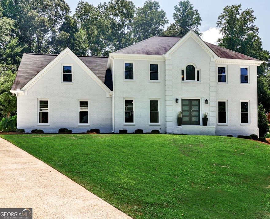 Welcome to this luxuriously elegant five-bedroom residence, where tasteful design meets modern comfort, and every detail has been thoughtfully curated. Offered fully furnished with premium designer pieces, this home provides a true turnkey living experience of exceptional quality and style.  Step through the double front doors into a soaring two-story foyer, where rich hardwood floors flow seamlessly across the main level. To your right, a refined office/parlor offers the perfect peaceful workspace; to your left, a sunlit dining room connects effortlessly to the beautifully appointed eat-in kitchen and breakfast nook, each with tranquil views of your private backyard retreat. The spacious family room invites relaxation and opens onto an expansive screened veranda with fireplace, overlooking the outdoor fire pit, perfect for crisp evenings or hosting friends on game day. Upstairs, you'll find a convenient laundry room, four generous bedrooms, and two full baths, including a spa-inspired owner's suite designed for ultimate comfort and retreat. The finished terrace level is a true highlight, featuring both interior/exterior entrances as well as its own driveway. This level offers an oversized bedroom with private en-suite bath, a game/living room, sleek kitchenette with bar seating, additional laundry center, half bath, and a golf cart garage. A golf cart is included for quick trips to the community pool, tennis, and pickleball courts! This versatile space adapts beautifully as a teen or in-law suite, entertainment hub, or income producing opportunity. All of this comes with the added charm of Milton and Alpharetta just minutes away, plus the benefit of lower Cherokee County taxes.