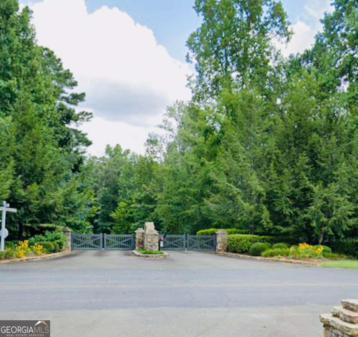 Discover your slice of North Georgia paradise with this beautiful property located in the scenic mountains of Ellijay. Nestled in a peaceful setting surrounded by nature, this lot offers the perfect opportunity to build your dream mountain retreat or forever home. Tranquility at Carters Lake is a gated community offering a playground, creek-side swings, picnic shelters with grills, and a craftsman neighborhood pavilion. Minutes from Carters Lake with a boat ramp and picnic area. The land provides both privacy and convenience, tucked away in a quiet area yet still convenient to the charming downtown Ellijay area with its local shops, dining, and seasonal festivals. Outdoor enthusiasts will love the proximity to hiking trails, rivers, vineyards, and award winning orchards that make this region such a desirable destination. Neighboring Blue Ridge GA has even more shopping, dining, and year around entertainment! Whether you envision a cozy getaway, or a spacious home with sweeping porches, this property gives you the flexibility to bring your vision to life. No matter the season, you'll enjoy the beauty and tranquility that Ellijay is known for. Also, zoned for the highly rated Gilmer School District. Don't miss your chance to secure a piece of land in one of Georgia's most sought-after mountain communities!