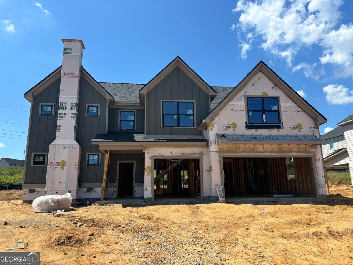 Built by SPI Homes - Homesite 45 in Phase Two - The Thompson floor plan - CUL-DE-SAC LOT & STONE CHIMNEY WITH BRICK FRONT ELEVATION. Estimated completion in November. Secondary Stock Photos. This impressive 3,300 sq. ft. home features 5 bedrooms, 4 bathrooms, and an open loft, designed for both comfort and style. The main floor offers a private guest suite with its own ambient fireplace and a full bath with a standalone shower-perfect for visitors or multi-generational living. The open-concept living area showcases a decorative electric fireplace framed by floating shelves and custom cabinets, flowing seamlessly into the luxury kitchen. Here you'll find quartz countertops, pendant lighting, a decorative vent hood, upgraded ceiling-height cabinetry with soft-close drawers, a pull-out double trash bin, and a premium Samsung stainless steel appliance package including a gas cooktop with wall-mounted pasta faucet, wall oven, and microwave. Elevated details are found throughout the home-unique millwork, shiplap accents, crown molding, timeless matte black finishes, and durable LVP flooring. Upstairs, retreat to the oversized primary suite with a custom trey ceiling and a statement accent wall. The spa-inspired bath includes a soaking tub, quartz countertops, and a generous walk-in closet with custom shelving. Three additional bedrooms, a versatile loft, and a convenient laundry room complete the second floor. Located in Hosch Reserve, a vibrant swim, cabana, and pickleball community, this home combines modern luxury with active lifestyle amenities. Nestled within Gwinnett's highly sought-after Seckinger High School district, Hosch Reserve offers a peaceful setting just off Old Thompson Mill Road. Buyer Incentive: $10,000 with a preferred lender. ?? Google GPS: Hosch Reserve