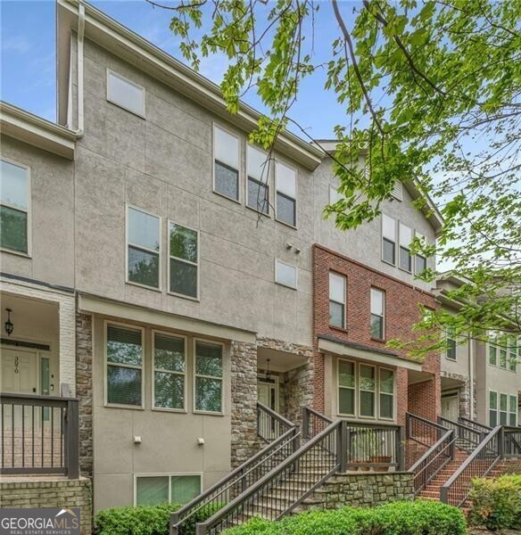 Spacious Chamblee townhome with an abundance of natural light with a convenient location with easy access to I-85 & I-285. The home features an open living area on the main level. The kitchen has granite counter tops, freshly painted cabinets, and huge walk-in pantry. The dining area is open flows into the kitchen and opens out onto the balcony. The balcony is large enough for a patio garden and sitting area. The living area features high ceilings with large windows for great natural light and gas fireplace for those chilly nights. The main floor also has a power room and guest suite with a large walk-in closet. The upper level features the primary suite with an oversized closet, coffee bar, and dual vanities in the bathroom. The laundry is convenient located on the upper floor along with another guest suite with a large closet. The storage space in this home is absolutely amazing! The home also features a one car garage with enough space for a second car in the driveway.