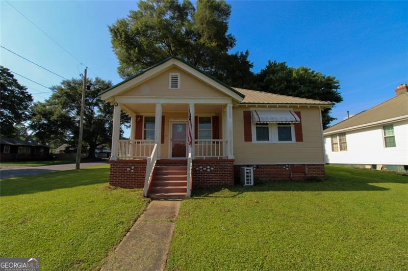 This charming 2-bedroom, 1.5-bathroom offers a blend of modern upgrades and classic charm on a spacious corner lot. The home features original hardwood floors, a fully upgraded kitchen with all appliances included, along with a washer and dryer that stay. Upgrades include new windows (2020), fresh interior paint (2025), a mini-split HVAC system (2020), and added half bath in the en suite. Brand new light fixtures and new kitchen flooring were installed in 2025. Additional features include a two-car garage, separate storage building, laundry/mudroom, and convenient parking in the back of the house. Move-in ready and perfect for a starter home or anyone looking to downsize.