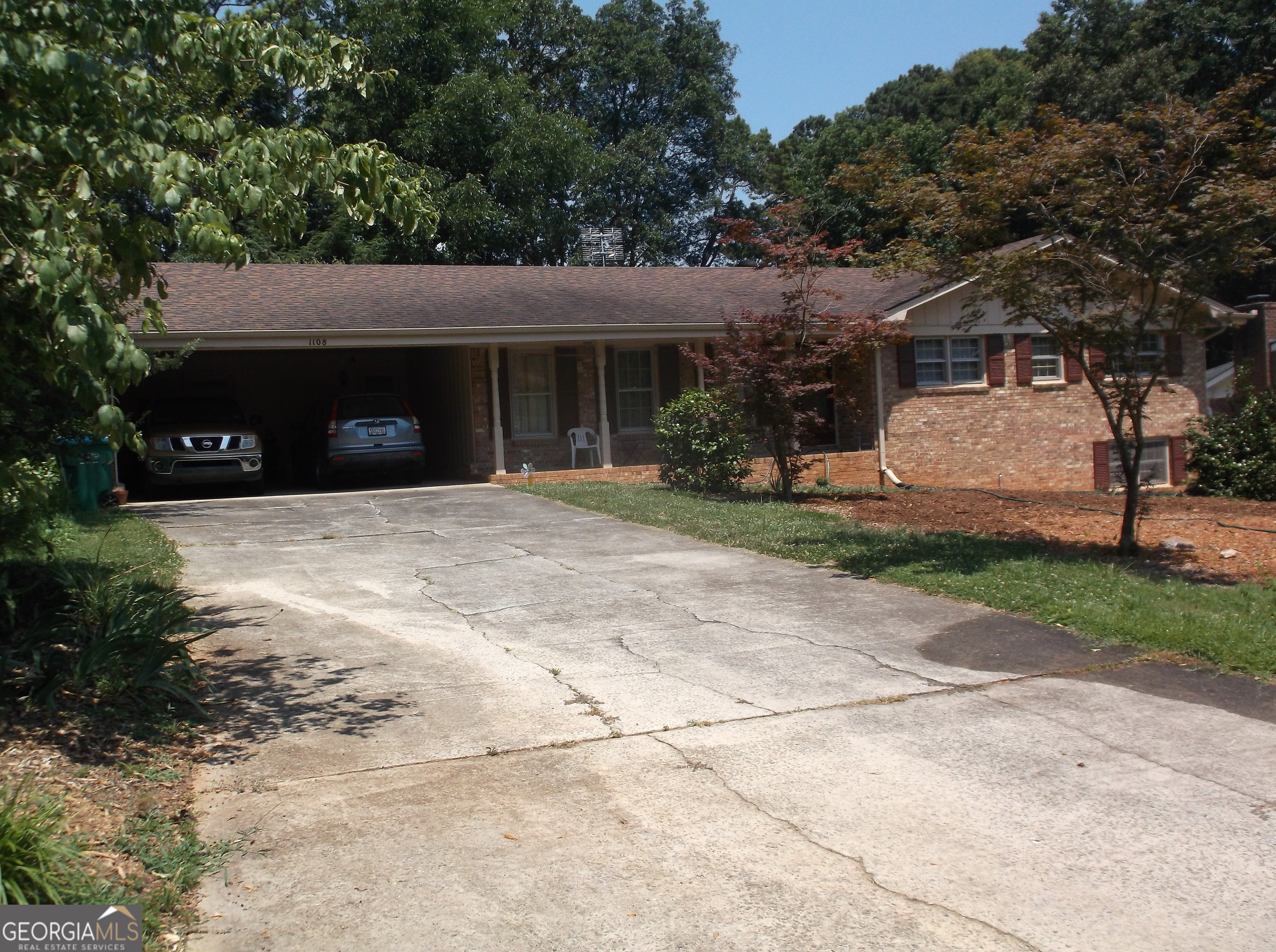 This is a vintage 1973 all brick Ranch on .47 acre. It is 3 bdrm 2 bath with the Jack and Jill bathroom floor plan. This home is in very good move in condition with some furniture included. The laminate flooring in the living rm, den and hallway were installed late 2023 and have minimal use. The carpet in 1 bed rm and the vinyl flooring in the kitchen/breakfast area and laundry rm installed in Jan 2024. The other 2 bed rm's carpet is new. When built the home had a few upgrades including pull chain lights in the bed rm closets and an outlet over the fireplace. The Dining Rm Chandelier is original and was a big upgrade in 1973. The Dining Rm table is circa 1965 American Walnut with 6 recently reupholstered chairs in excellent condition, are included. The HVAC system was installed Jan 2025 and is a NG 80% efficient 80k BTU unit with a 3 ton AC unit. The water heater, cooktop and wall over are also NG. This home is in the Mountain Park area of Lilburn off Five Forks Trickum with easy access to Rockbridge Rd. It is within a 20 minute walk of 3 parks, a Library, and shopping. Please note the property tax listed is without the Homestead Exemption.