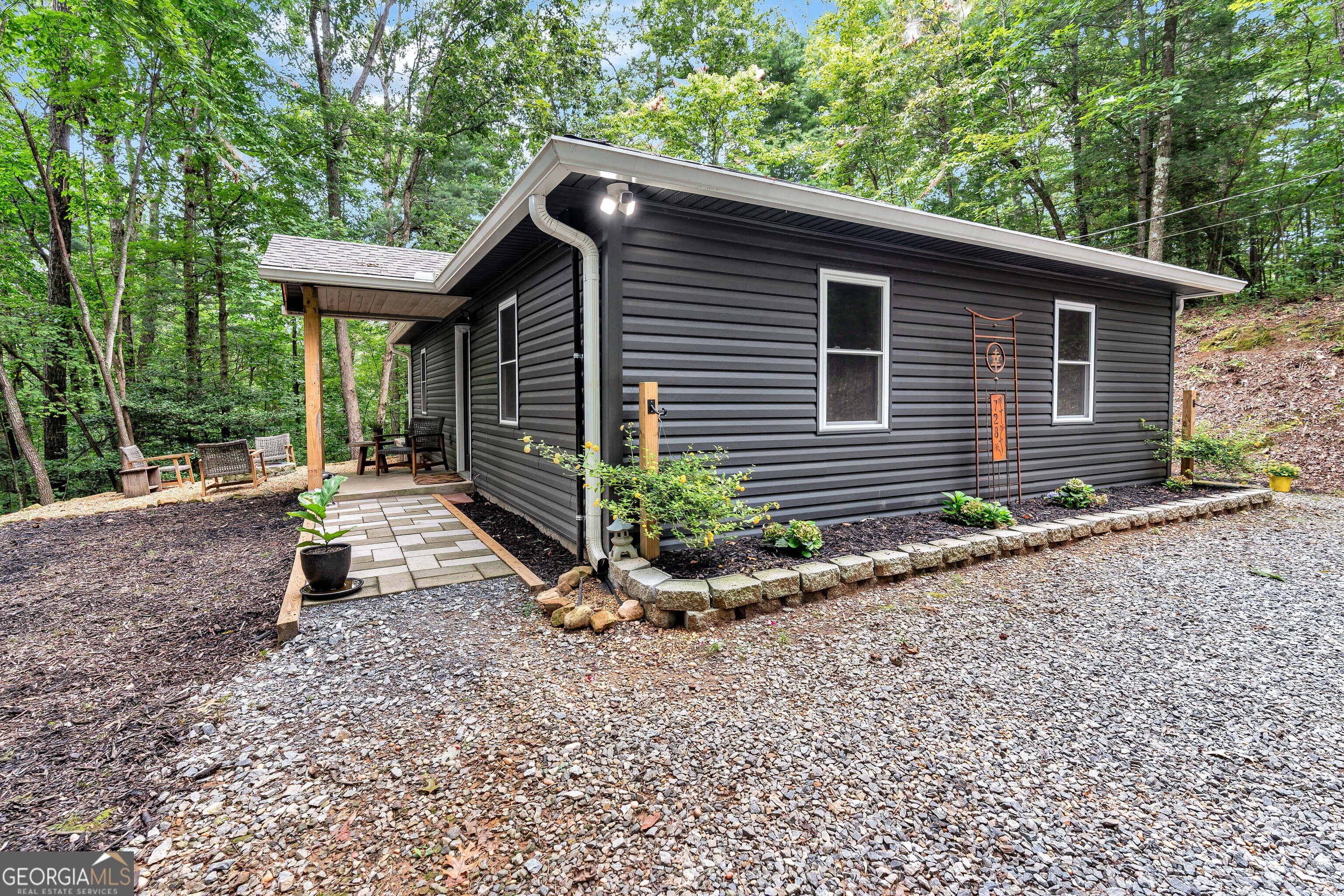 Nestled in the quiet woods of Ellijay, this charming 2 bed, 1 bath single-level home offers peaceful mountain living with modern updates. Recent upgrades include new appliances, windows, roof, and a Generac generator-making this retreat move-in ready. Enjoy total privacy with a spacious yard, fire pit, and outdoor dining area, all with no HOA, no restrictions, and just a short drive to town. Perfect for a full-time home, weekend escape, or investment property! This home is a must see!
