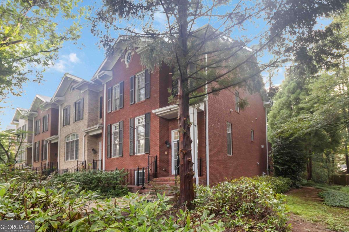 Experience luxury living in one of Atlanta's most sought-after locations! This beautifully updated 3-bedroom, 3.5-bathroom home is in pristine condition and offers not just one-but two-flexible living spaces to suit your lifestyle. Located in the exclusive gated community of Kingston Gate, you'll enjoy unmatched convenience just minutes from I-285, I-85, and GA-400-all while benefiting from DeKalb County taxes. Natural light pours through elegant transom windows on the main floor, accentuating the open-concept layout. The gourmet kitchen is a chef's dream, featuring granite countertops, modern stainless steel appliances, and a functional flow into the stylish butler's pantry. This space includes a custom bar area with designer pull-out drawers and shelving by Closet by Design, seamlessly connecting to the formal dining room-perfect for entertaining. The cozy living room offers built-in shelving and a fireplace, creating a warm and inviting ambiance. Just off the breakfast nook, a bright flex space is ideal for a home office, reading corner, or creative retreat. Step outside onto the serene back deck and enjoy tranquil views of nature-your own private escape. Upstairs, the spacious primary suite is a true retreat with a cozy sitting area and a luxurious ensuite bath featuring a soaking tub and separate glass-enclosed shower. The walk-in closet has also been thoughtfully upgraded with Closet by Design enhancements. An additional upstairs bedroom includes a private full bath for guest or family comfort. The daylight terrace level provides even more space with a third bedroom, full bath, and another versatile flex room-perfect for a gym, media space, or guest suite. Located close to shopping, dining, parks, and top-rated schools, this exceptional home blends luxury, comfort, and convenience. Don't miss your chance to call this Atlanta gem your own!