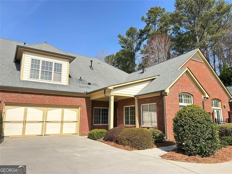Welcome to Brookhaven of East Cobb, a sought-after gated 55+ community where comfort, convenience, and connection come together seamlessly. This beautifully maintained home offers the best of single-level living with the added bonus of a versatile upstairs suite-perfect for guests, a hobby room, or a private retreat. As you step inside, you're welcomed by an open, airy layout with soaring vaulted ceilings that fill the home with a bright and inviting atmosphere. Natural light embraces the space, enhancing its warmth and charm, with select windows featuring custom wood blinds for both style and privacy. The spacious living area, anchored by a Heat-N-Glo gas fireplace, offers warmth and ambiance at the touch of a button-perfect for relaxing or entertaining. The gourmet kitchen is as stylish as it is functional, featuring polished granite countertops, premium stainless steel appliances, and custom, stained cabinetry-offering plenty of storage and workspace, whether you're preparing a quiet meal for yourself or hosting family and friends. Just off the kitchen, a flexible space can be used as a formal dining area for hosting intimate dinners or larger gatherings or easily transformed into a sitting room, reading nook, or personal study-whatever best suits your lifestyle. Designed for easy, comfortable living, the home features wide doorways and step-free entry. The primary suite is a true retreat, with a spa-like bath, double vanities, and a generous walk-in closet. Upstairs the private guest suite includes a full bath and walk-in storage closet, providing space for seasonal decor, luggage, or keepsakes. Plus, the walk-in attic offers easy access to the HVAC system, making maintenance and filter changes a breeze-no attic ladders needed! Outdoor spaces are just as inviting, with a covered front porch that's perfect for morning coffee and a private brick-enclosed courtyard-a peaceful spot for unwinding with a good book or enjoying an evening glass of wine. Beyond the front door, Brookhaven of East Cobb offers an exceptional lock-and-leave lifestyle, with the HOA handling all exterior maintenance and landscaping. Enjoy resort-style amenities, including a clubhouse, fitness center, and pool, where neighbors quickly become friends. Sidewalk-lined streets make it easy to take a leisurely stroll to the clubhouse, chat with neighbors, or simply enjoy the manicured surroundings. Located in a prime East Cobb location, this home is just minutes from shopping, dining, medical facilities, and entertainment. Whether you're looking for low-maintenance living, modern comforts, or an active social community, this home checks all the boxes. Come see it for yourself-schedule your private tour today!