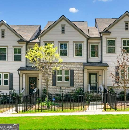 Modern living meets convenience in this beautifully maintained townhome located right in the heart of Towne Lake-one of Woodstock's most popular and vibrant communities! With an open layout designed for both relaxing and entertaining, this home offers plenty of natural light, stylish finishes, and practical upgrades throughout. The main level welcomes you into a spacious living area that flows easily into the kitchen and dining space. You'll love the oversized island, walk-in pantry, and sleek finishes that make everyday life feel a little more elevated. Upstairs, the primary suite gives you the space you've been craving-complete with a walk-in closet, double sinks, and a modern glass walk-in shower. Two additional bedrooms, a full bath, and a laundry room round out the top floor, offering flexible options whether you need a guest room, home office, or both. The finished terrace level is a bonus you'll actually use, featuring its own full bath and the perfect space for movie nights, out-of-town guests, or your work-from-home setup. Outdoor living is just as impressive-think private back deck, a cozy covered front porch, and a fenced front yard for pets or playtime. Tucked into a peaceful, sidewalk-lined community, this home offers direct access to the Greenprints Trail system and is just minutes from Downtown Woodstock, local breweries, the Outlet Shoppes at Atlanta, and top-rated schools. This is more than a rental-it's a lifestyle in one of the best spots around. ****RENTAL REQUIREMENTS****: Credit & background check required for each resident over age 18. NO felony convictions, NO bankruptcies, NO evictions, NO Smokers, NO subleasing or AirBnB. Income requirement: MINIMUM 2x monthly rent in VERIFIABLE/DOCUMENTED household income. Submit 3 most recent pay stubs & last 3 bank statements for each adult (or 2yrs of tax returns if self-employed or 1099). Renters insurance required. $75 non-refundable fee p/adult + $250 non-refundable admin fee if approved for lease. ****