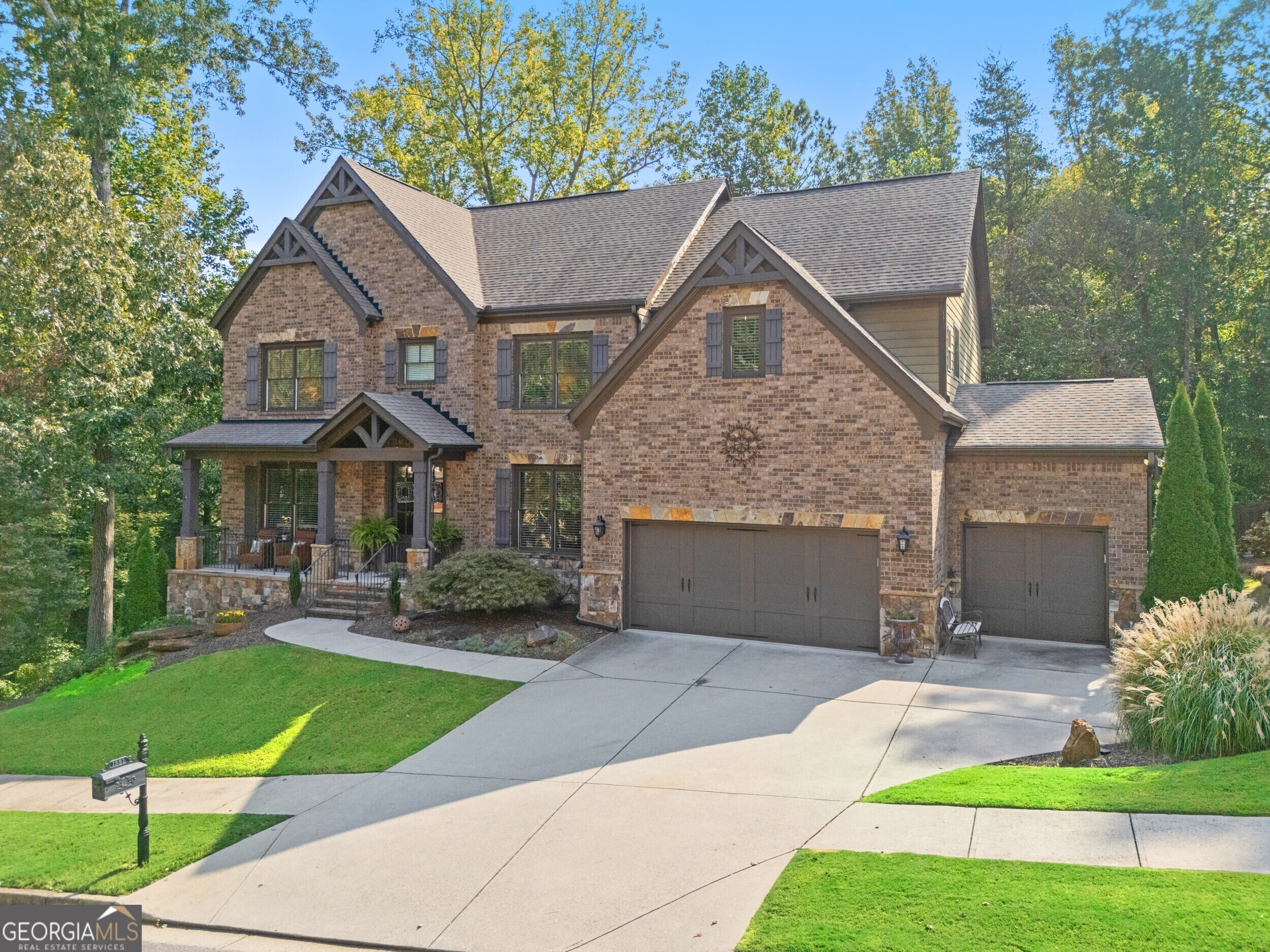 **Welcome Home to Exceptional Living in Ashbury Park**Set within the prestigious Mill Creek School District, this exquisite 5-bedroom, 4-bathroom home perfectly balances timeless elegance with everyday comfort in the desirable swim and tennis community. From the moment you arrive, the inviting front porch and impressive double-door entry welcome you into a soaring two-story foyer, setting the stage for the refined craftsmanship found throughout. Newly refinished hardwood floors, rich custom millwork, and streams of natural light create a warm yet sophisticated atmosphere across the main level. Thoughtfully designed living spaces include a formal dining room, a quiet home office or library, and a guest suite with a full bath ideal for hosting overnight visitors or multigenerational living. At the heart of the home, the stunning two-story great room makes a statement with dramatic coffered ceilings, a stately stone fireplace, and custom built-ins all framed by expansive windows with tranquil views of the wooded backyard. The open-concept gourmet kitchen is a true showstopper, boasting crisp white cabinetry, elegant stone countertops, a charming window over the sink, and seamless flow into the great room and covered porch the perfect spot for your morning coffee or winding down in the evening. Upstairs, the luxurious primary suite offers a peaceful retreat, complete with a cozy sitting area, a spacious spa-inspired bath, and a generous walk-in closet. Three additional bedrooms share a well-appointed bath, while a dedicated media room is ready for movie night or game-day gatherings. The unfinished walk-out basement presents endless possibilities for customization, and opens to your very own backyard oasis a private, wooded sanctuary overlooking a serene pond. Whether it's casting a line in the pond at sunset or roasting smores under the stars, this backyard was made for memories. With unmatched style, functionality, and a prime location, this home truly offers the best of Ashbury Park living. Your next chapter begins here. Don't let it pass you by.