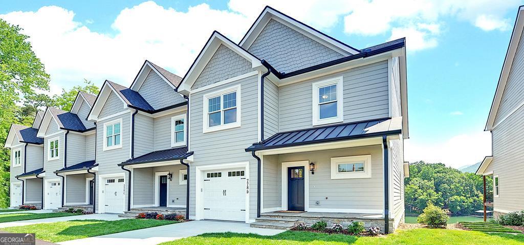 Luxury on Lake Chatuge! Stunning, spacious lakefront townhomes, with a covered community dock. When you step through the front door you'll notice the detailed craftsmanship and high-end finishes. The foyer leads to an expansive, open-concept great room, which comfortably accommodates family & guests as they enjoy the stone-front, gas-log fireplace. Beautifully appointed kitchen boasts a large island, ample cabinetry, and KitchenAid appliances. Adjoining dining area is large enough to seat 6-8 people. Step out back and enjoy views of the lake from one of three outdoor living spaces. Every townhome is equipped with an elevator, so head on up to see the three bedrooms & two full bathrooms, including a gorgeous owners' suite, with a picture window overlooking the lake. One of two laundry rooms is located on this level. On the terrace level, there is a large living space with a wet bar, another laundry, another bedroom with ensuite, and a fourth full bath. A patio and walkway lead you down to the dock, with a fish/swim platform. These townhomes are in the heart of Hiawassee, offering convenient access to shopping and several casual and fine dining options. Why Hiawassee/Lake Chatuge? Hiawassee is a quaint, small-town community with a 7200-acre lake in our backyard. We have all the amenities you need, without the crowds and traffic you'll find around other area lakes. Georgia is ranked among the top states for retirees. If you're unfamiliar with this area, you must explore all we have to offer. . . hiking, boating, world-class bass and trout fishing, pristine golf courses, luxury resorts and spas, and pickleball, just to name a few. The area is known for its festivals and is home to the Georgia Mountain Fairgrounds. If you're thinking about full-time living here, you'll find that medical, dental and vision care in this area is excellent. Come home or invest in luxury on Lake Chatuge! End units are $1,100,000. Other units are available. Owner financing is available - interest only at 5% interest with 25% down. Other terms to be negotiated.