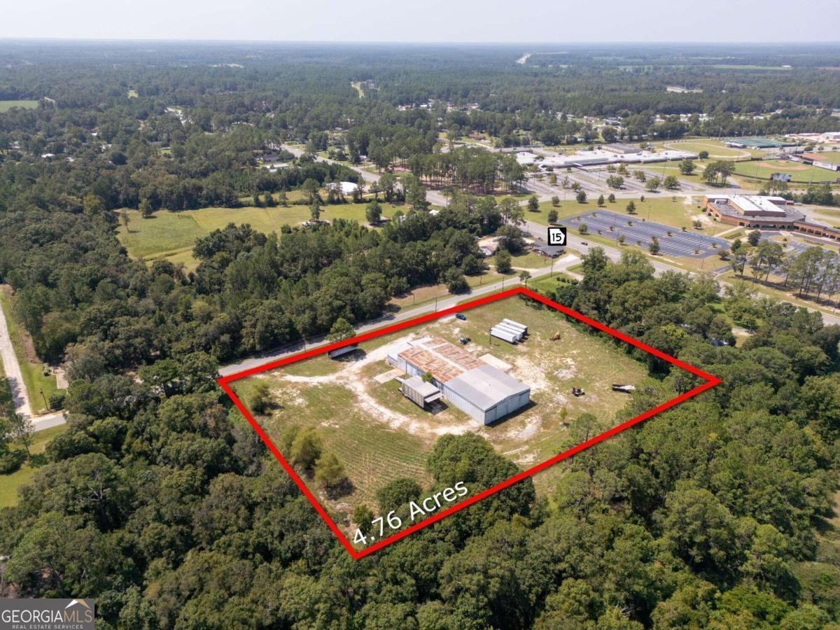 4.76 acre lot with commercial building off of Hwy 15 in Baxley, GA. With a 14,000 sq ft warehouse with multiple entry points and additional 2,080 sq ft office building make this a versatile property. Lakeview Drive provides quick access to Hwy 15 and City Circle Rd which directly connects to the major trucking route Hwy 341.
