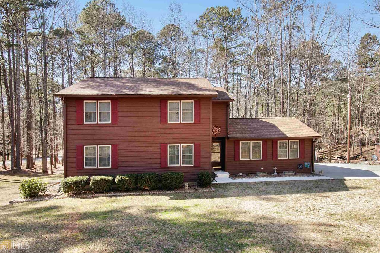 Welcome to this well maintained 3 bedroom 2.5 bath home in the exclusive Eastwood Estates neighborhood in Newnan. This home is located at the end of a no outlet street so that means no thru traffic! Great privacy as there are no neighbors beside you and at the end of the backyard is a brook to walk to and enjoy. Enter into the house and turn left you will walk into the family room that has high ceilings, letting in great light from the outside. Off of the family room is the dining room and around the corner is the kitchen that has self closing cabinets, stainless steel (all matching) appliances and some great racks built inside of a cabinet to store pots and pans and their lids! You can see what’s happening in the family room from the half wall that is open in the kitchen that’s above the sink. Exit the kitchen on the other end there is a half bath and laundry and walk back out into the family room again. The stairs leading to the upstairs have been refinished and stained, adding a rich wood tone to this home. All 3 bedrooms are upstairs and from the top of the stairs you can overlook the whole entire family room! Cozy layout and lots of room for extra storage with the 2 outbuildings in the backyard. This home is in a sought-after location with great schools and a short ride to the interstate and shopping. Make your appointment today!