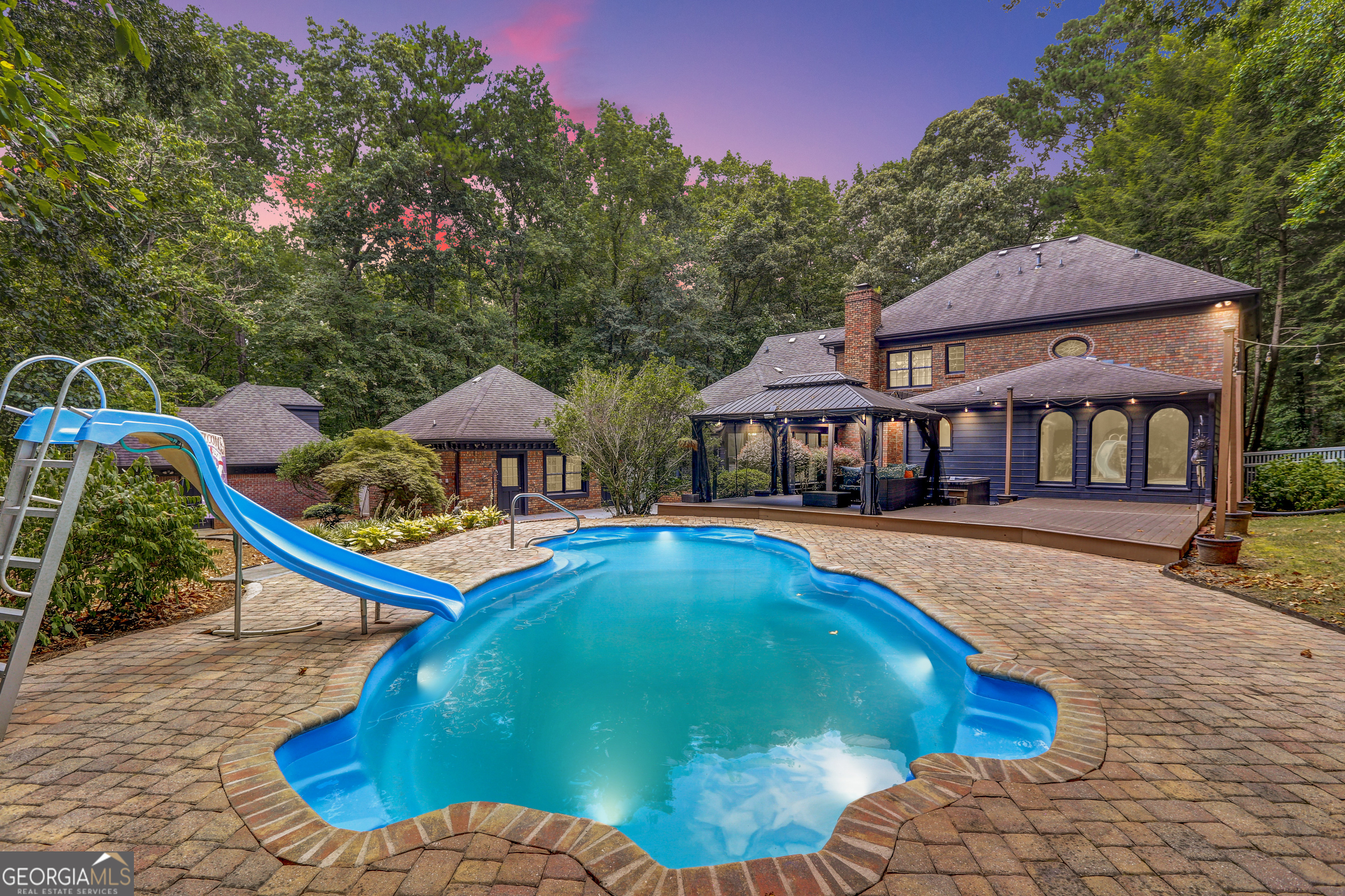 Offered at $1,100,000 (NO HOA) | 5 Beds | 4.5 Baths | 2.4 Acres | Brookwood School District | Tucked away on a serene 2.4 acre estate in the prestigious Brookwood school district. This private retreat offers a rare combination of luxury, versatility, space & Short Term Rental or AirBnb income potential. Just 10 miles from Stone Mountain Park. Welcome to 1435 Jay Court-a private, luxurious haven that's perfect for multigenerational living, remote professionals, or anyone who values privacy and elegance. From the moment you enter the long private driveway, you're greeted by mature landscaping, a stately brick exterior, and an oversized 4-car garage with workshop. Inside, the home boasts 5 spacious bedrooms, including dual owner's suites-one on the main level with a sitting area and tranquil pool views and another upstairs ideal for extended guests or family. The heart of the home is the gourmet kitchen, featuring custom cabinetry, premium finishes, and seamless flow into the dining and living areas-perfect for entertaining. Enjoy hardwood floors throughout, tile in the kitchen and sunroom and a fully finished basement ideal for a game room, office, or media space. Step outside to your own resort-style backyard, complete with a sun-drenched pool, oversized sunroom with floor-to-ceiling windows, and a fully functional detached pool house with a private bath and its own entrance-perfect as an in-law suite, guest apartment, or short-term rental opportunity. Less than 5 minutes from major shopping, dining, and conveniences-yet peacefully tucked away-this home is a true hidden gem. The motivated seller is relocating for work, so bring all serious solid offers! Verifiable Proof of Funds required for Showing Appt. No exceptions. For a Showing Appointment Call 1-800-746-9464