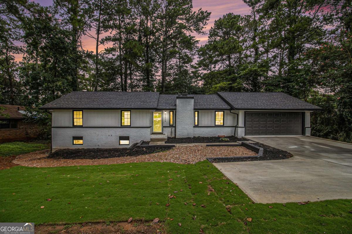 GORGEOUS, MODERN RENOVATION! $5,000 TOWARD RATE BUY DOWN! Additional income opportunity to offset the mortgage with the full, finished basement with 2 bedrooms, a full bathroom, kitchen and additional storage. Average rent in the area is $1,395/month. The front entryway welcomes you into the spacious living room with grand vaulted ceiling, feature wall and exposed beams. The separate sitting area features a cozy fireplace. Enjoy the Chef's kitchen surrounded by white cabinets, breakfast bar seating, granite countertops, elegant marble backsplash, additional bar seating, eat-in kitchen area, and all new appliances featuring a French door fridge and ceramic-top range. Plenty of room for entertaining! Relax in your primary bedroom retreat featuring a walk-in closet. The ensuite primary bathroom with double vanities showcases an oversized tiled shower with rainfall showerhead. Outside, discover the new spacious deck, perfect for entertaining, playing, or relaxing. The 2 car garage and level driveway allows ample room for parking for friends, family & guests.
