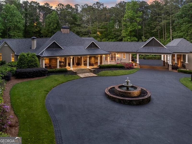 Redefine your luxury! Discover Five O'Clock Farm...an iconic +/- 33 Acre Country Estate and HORSE FARM offering a blend of timeless design with exquisite quality in every detail. Coveted SE Cherokee location bordering the Little River and City of Milton at the end of of one of the most beautiful and scenic upscale country roads in all of north Atlanta. Promising an elevated lifestyle, this farm embraces absolute tranquility and graceful beauty. Architecturally stunning ranch home is understated as it extends along the landscape at the end of a private gated drive. Handsome interior finishes create a classic warmth throughout with touches of southern styling. Postcard perfect views from every room, porch and patio. One level living with easy accessibility and flow, enveloping a resort style courtyard with sports pool (approx 30' X 20'), spa and expanded fireside stone pavilion. A perfect setting for large gatherings of friends and family. Wide portico joins an oversized 4 car garage with extra tall/wide doors to accommodate trucks and a full use unfinished attic above. INTERIOR: Rich wood inset cabinetry in this Chef's kitchen with 6 burner/pot filler Viking(r) cooktop, oven/microwave, Subzero(r) refrigerator & wine cooler, Scotsman(r) ice maker, bar sink. Scullery back kitchen with additional Thermador(r) oven & second dishwasher, counter space & inset cabinetry. Mud room opens to portico. Primary suite with fireside sitting room and steam shower on main level as are 3 spacious en-suite bedrooms. Additional en-suite bedroom up for a total of 5 bedrooms and baths, all updated. Old world inspired stone masonry fireplace in family room is as grand as it is tall. Media/recreation room on main level with walk out access to pool, plus additional office space. Large craft or storage room upstairs. GROUNDS AND FACILITIES: +/- 33 acres with approx 10 acres in pasture and over 15,000 linear feet of 4 board fencing around property and 4 horse paddocks. 6 STALL HORSE BARN (42'X60') with one bedroom apartment above and new deck. New electrical wiring and light fixtures in barn, freshly painted in 2023. 4 run in sheds, one in every fenced paddock; power and water run to the paddocks; Two ponds, one with aeration fountain; separate gated paved drive to barn. ADDITIONAL DETAILS: New roof 2021 (Approx 6200 ft under roof); foam insulation in attic; 32 kw whole house generator, gas fired; majority new windows and french doors; 6 HVACS; 3 water heaters; custom fabricated automatic security gates for home and barn; new twin tank 500/1000 septic at house; natural gas; house on County water, well with new pump for barn and irrigation; 30 amp camper plug convertible to 50 amp; Comcast Xfinity business size high speed internet. Whole home indoor/outdoor Sonos audio system. LOCATION: Country Estates area of Cherokee County is protected by land use plan, 2 acre minimum lot sizes and is known for lower property taxes as well as good schools. Easily accessible to all upscale shopping, urban centers and only 10 miles to downtown Alpharetta and Crabapple. Property eligible for Conservation Use Valuation Assessment (CUVA) for reduced taxes if used as a bonafide agricultural property. See Cherokee County Tax Assessor for details.
